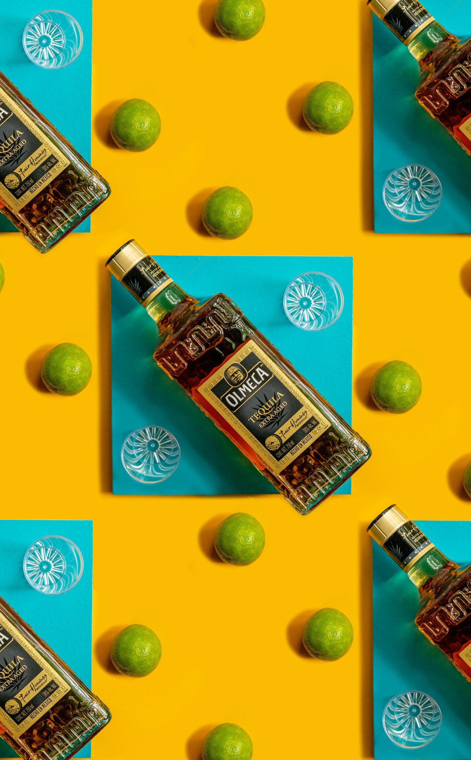 Olmeca tequila bottles arranged in geometric pattern with fresh limes on yellow and turquoise background.