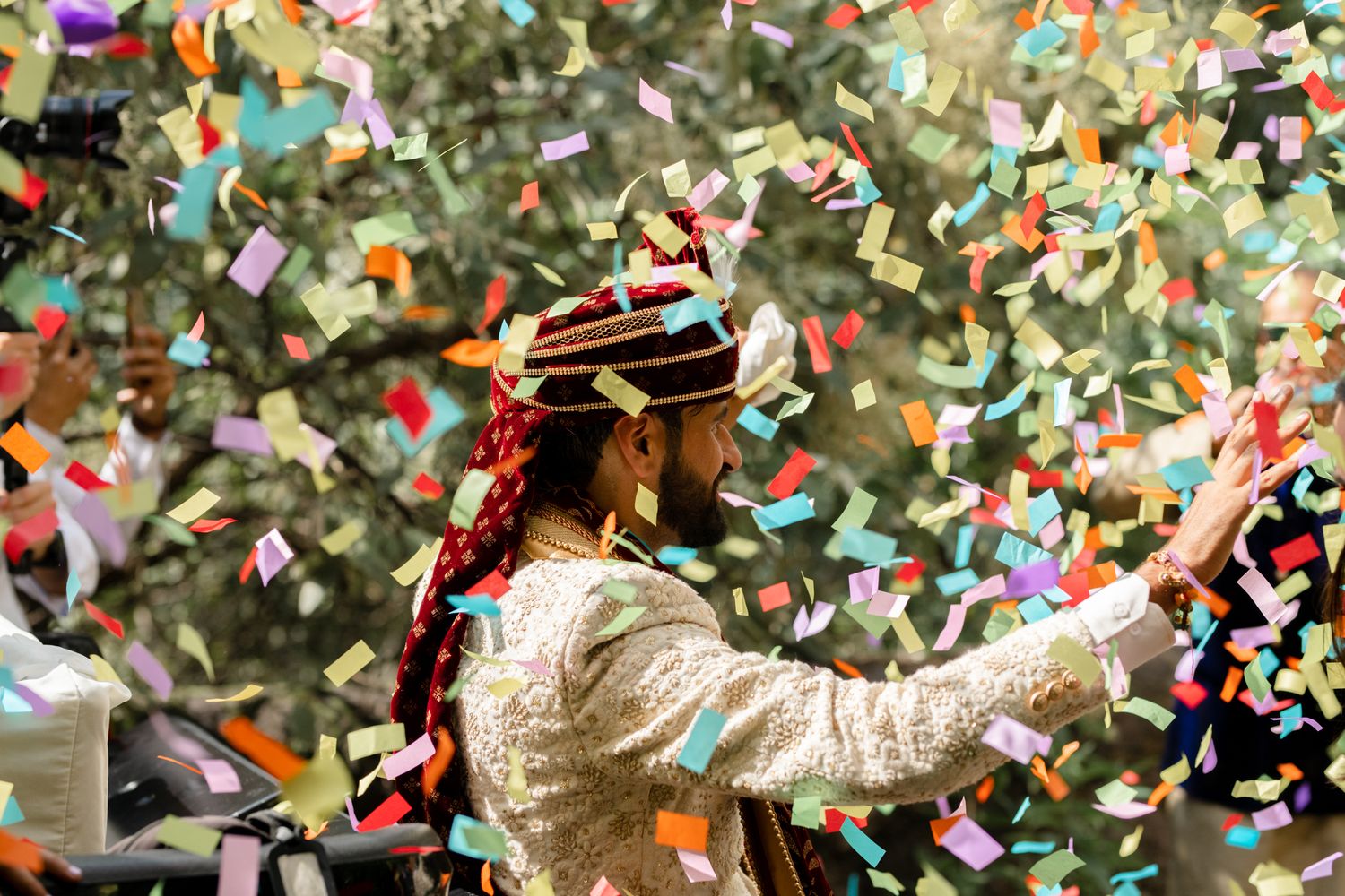 A joyful celebration scene with colorful confetti raining down as a person in a white sequined outfit dances.