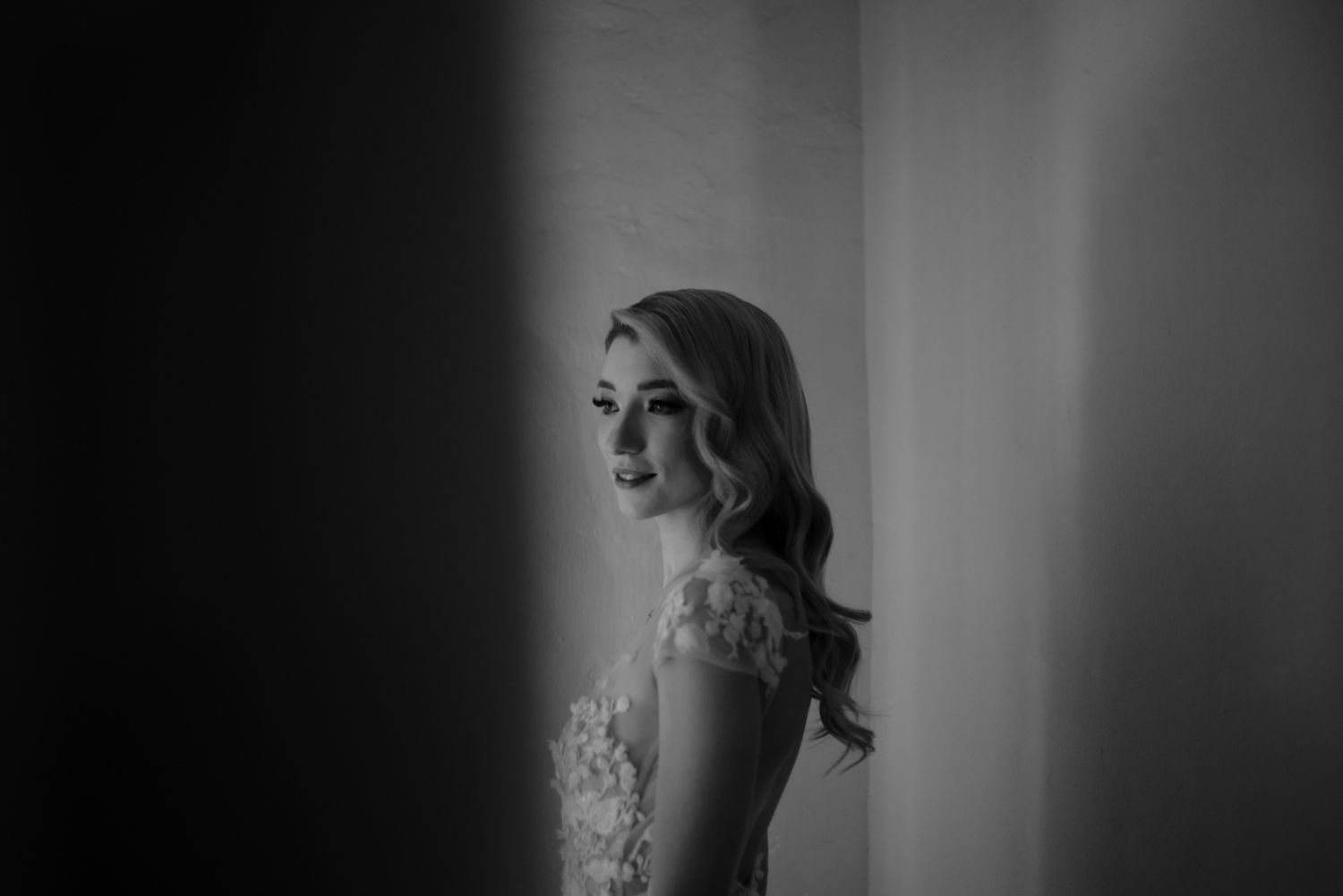 Black and white portrait of a bride in soft window light.
