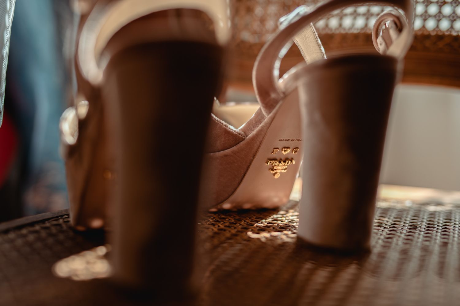 Coffee cups sitting on a textured metal surface captured with shallow depth of field in warm lighting.
