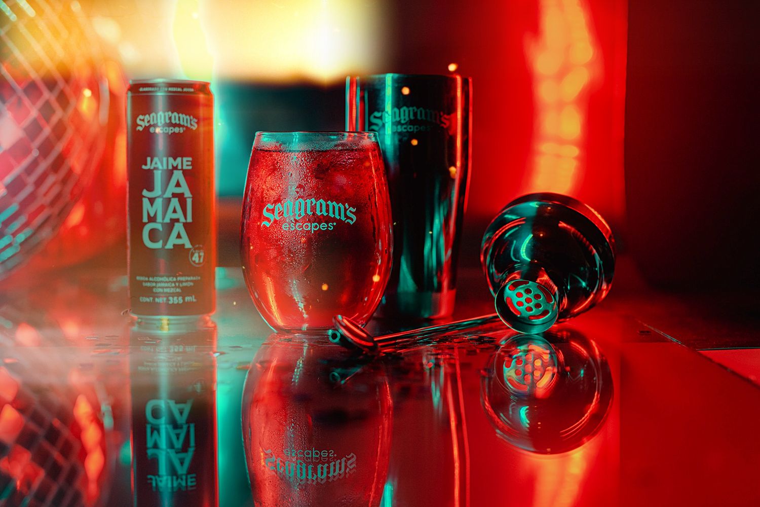 Red-lit product photography of cocktail glasses and bottles with reflective surfaces.