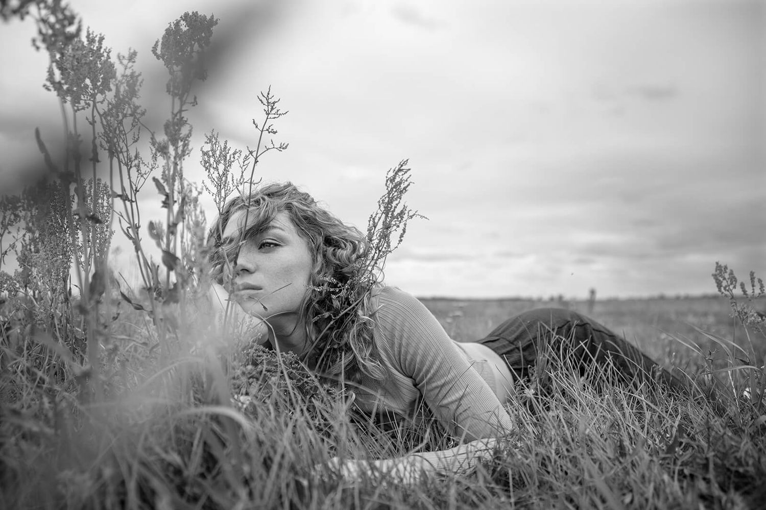 Moody black and white landscape portrait with natural elements creating atmospheric effect.