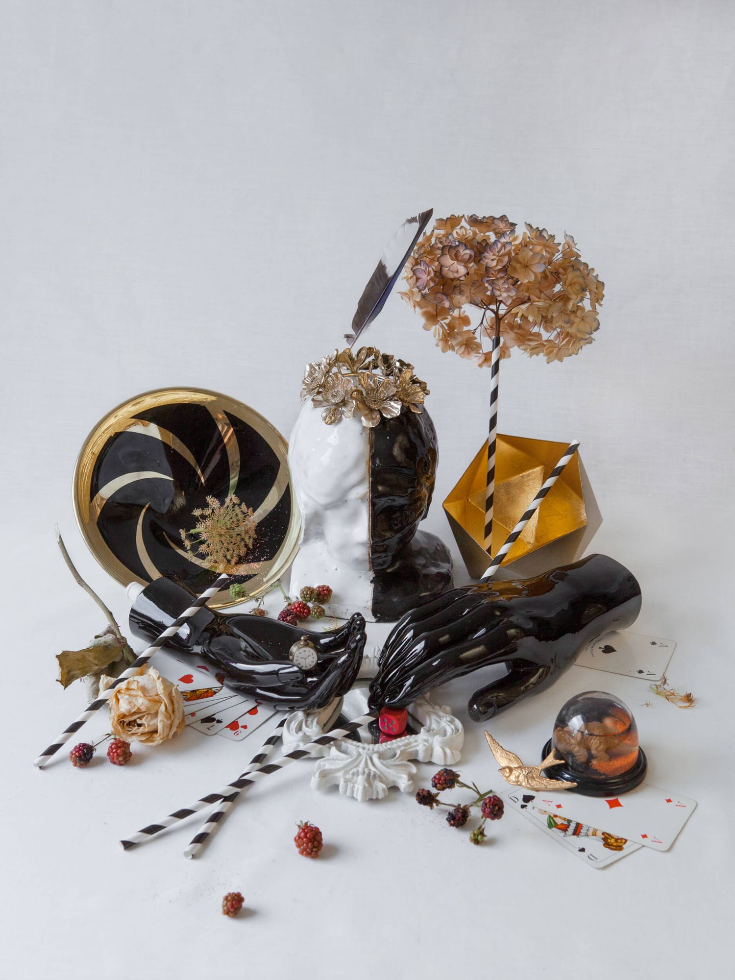 Dark moody still life with dried flowers, vintage items and decorative elements.