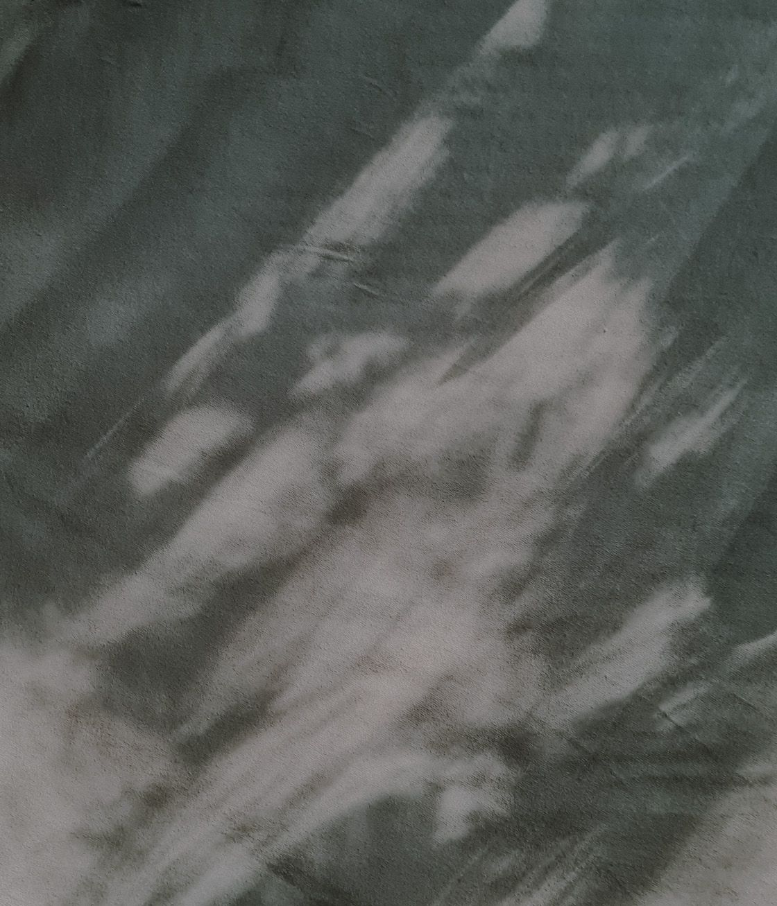 Abstract blurry pattern of dark green and white streaks creating a dynamic marbled texture effect.