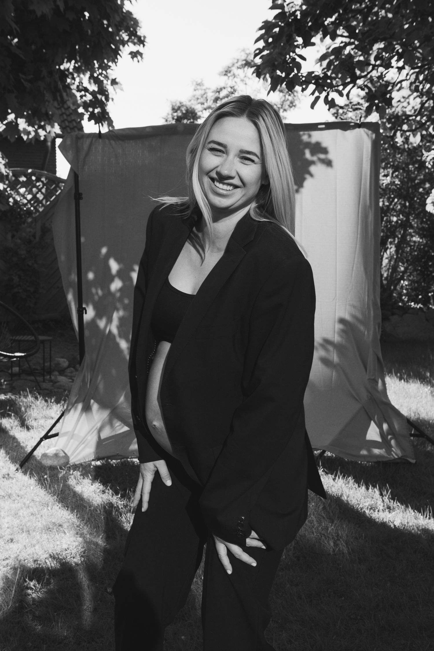 Outdoor portrait session with white backdrop and natural lighting creating candid moments.