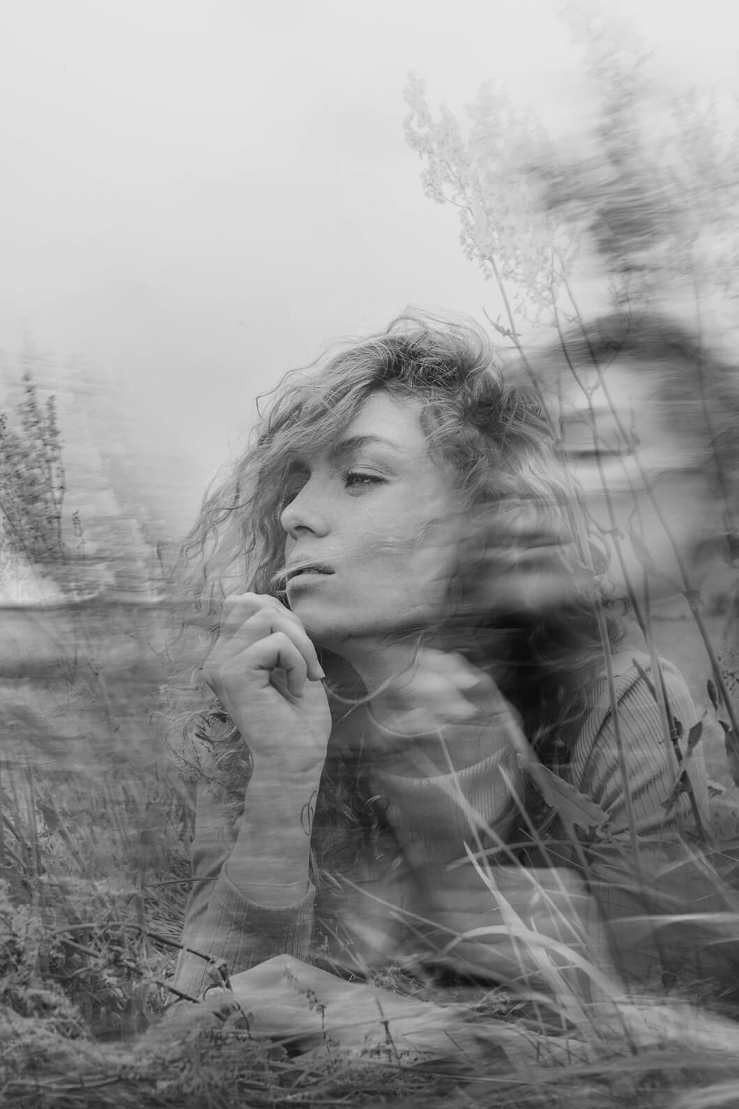 Multiple exposure black and white portrait creating dreamy, ethereal effect.