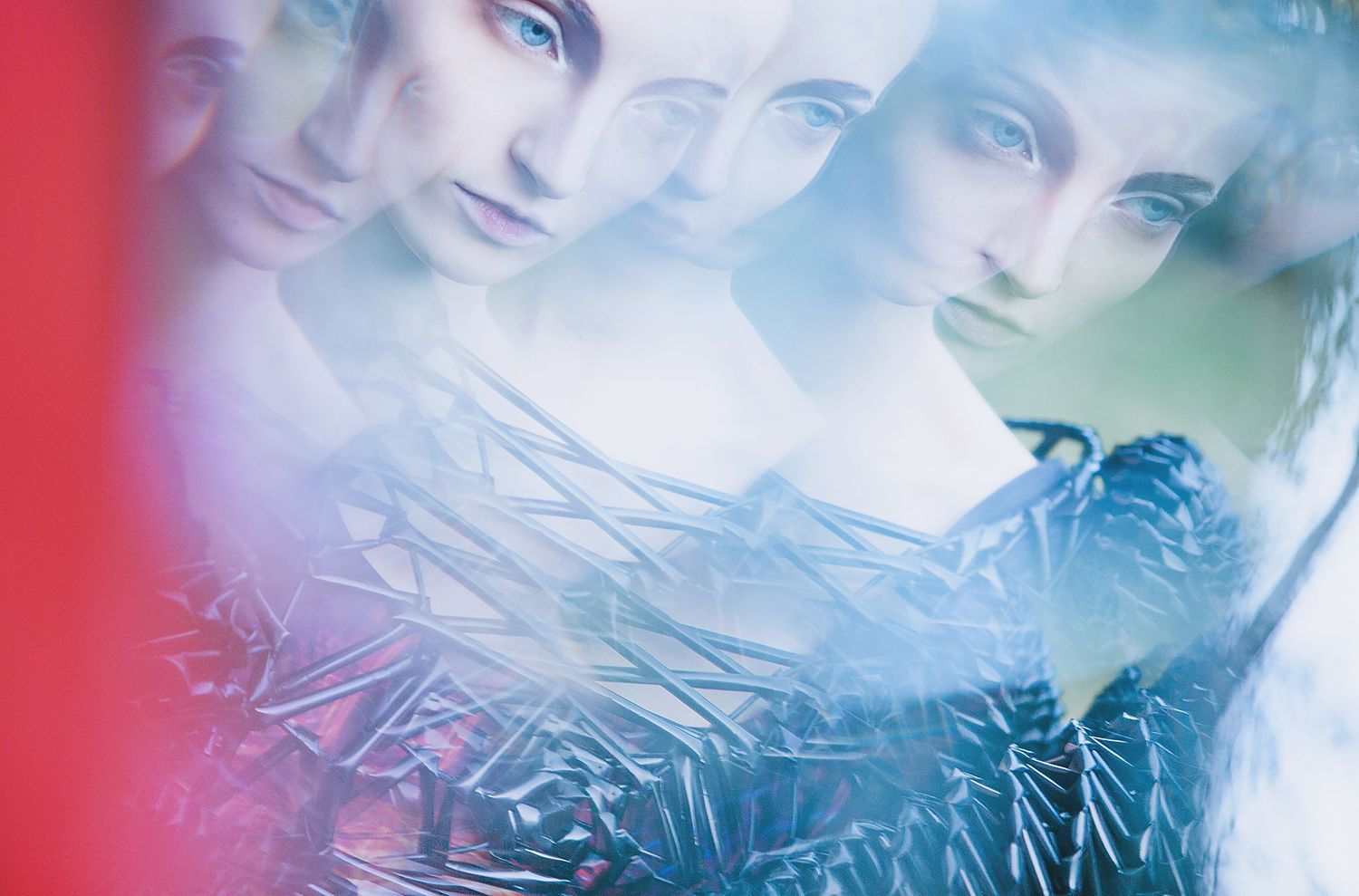 Multiple exposure portrait with ethereal blue and red lighting effects.