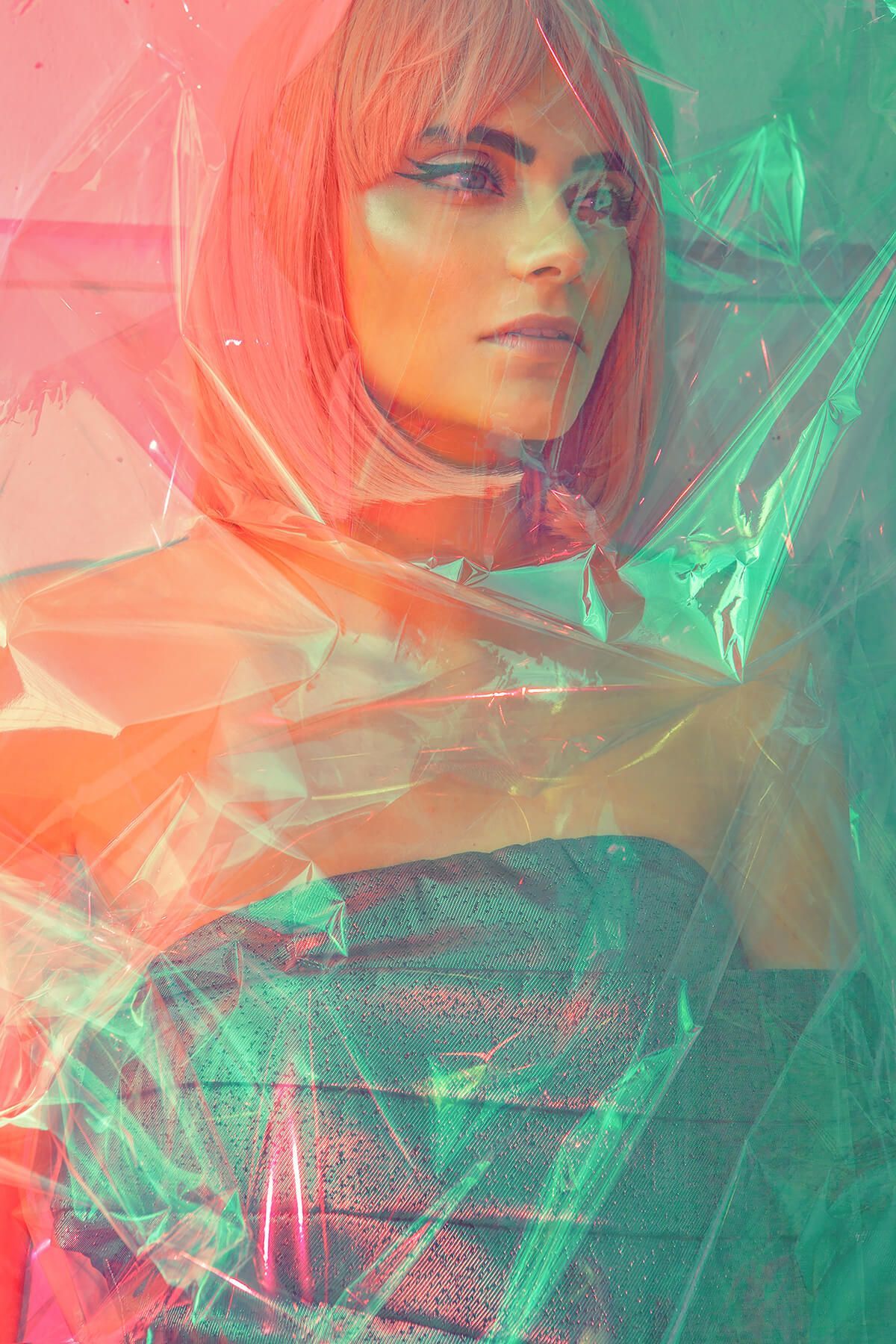 Abstract portrait photoshoot with pink and turquoise color overlay effects creating a dreamy artistic look.