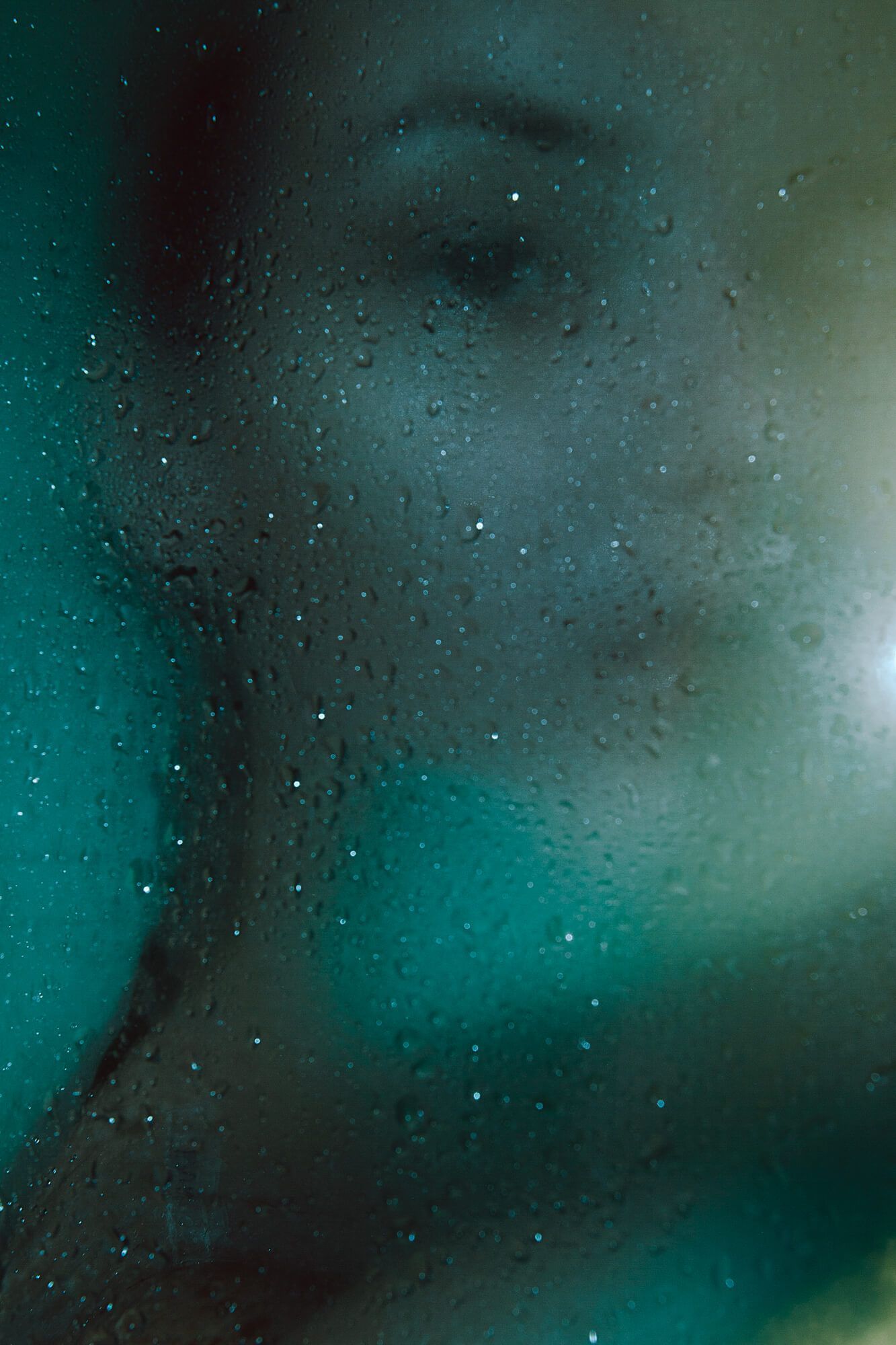 Abstract macro photography of water droplets with teal color gradient.
