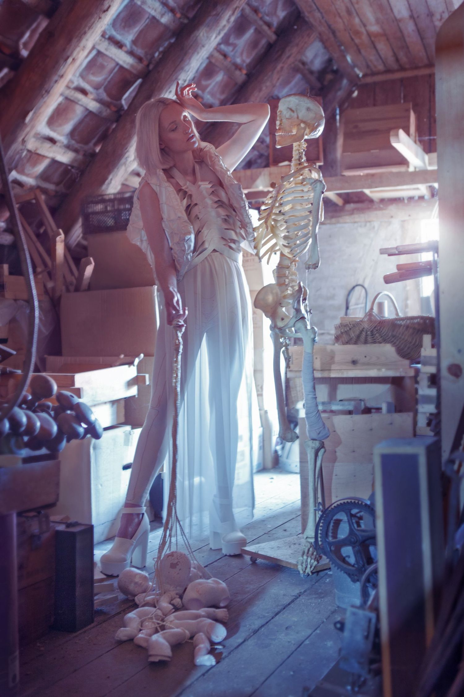 Ethereal indoor photoshoot with light streaming through windows creating dramatic silhouettes.