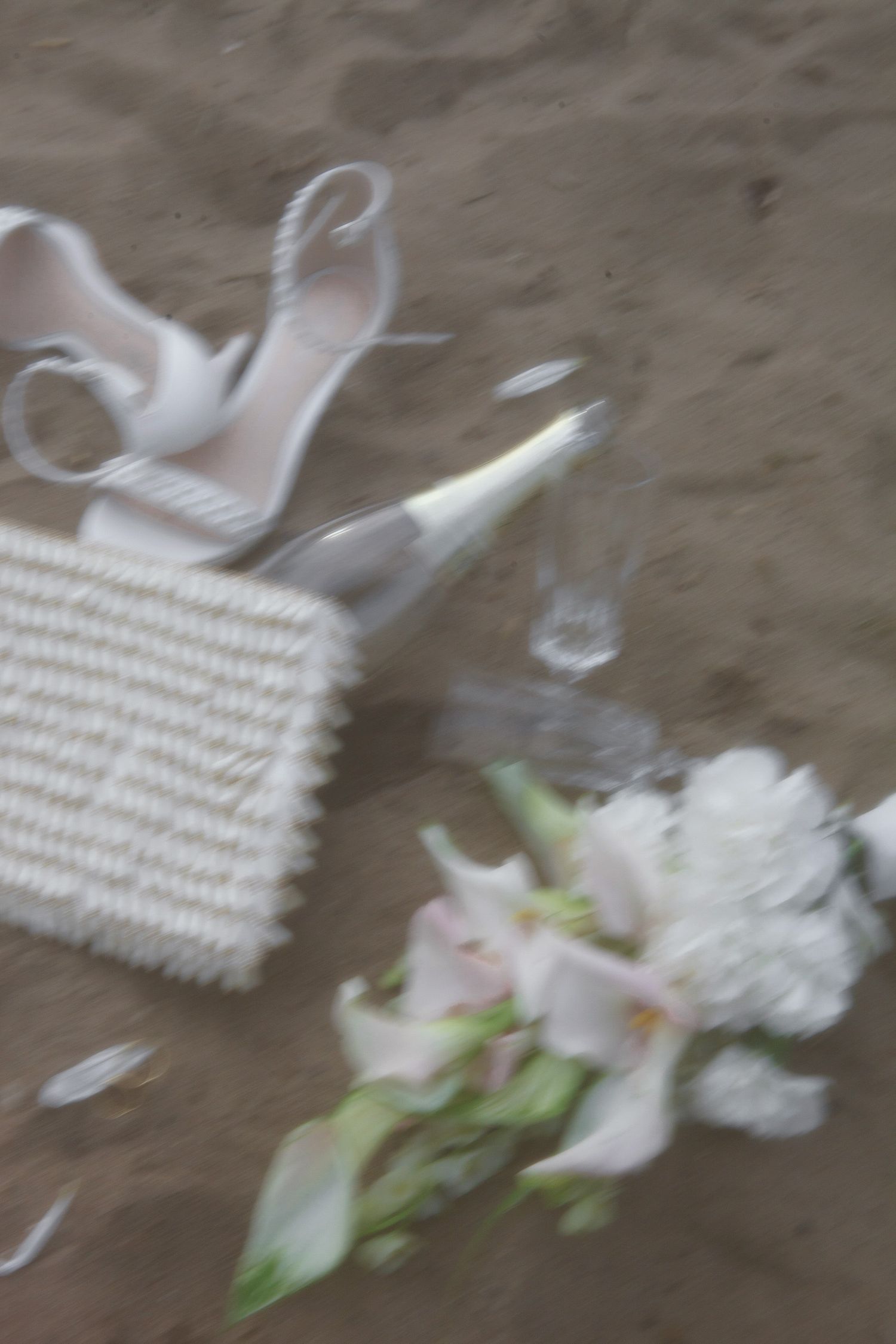 Blurry sequence showing white woven basket pieces and flower petals scattered on a brown surface.