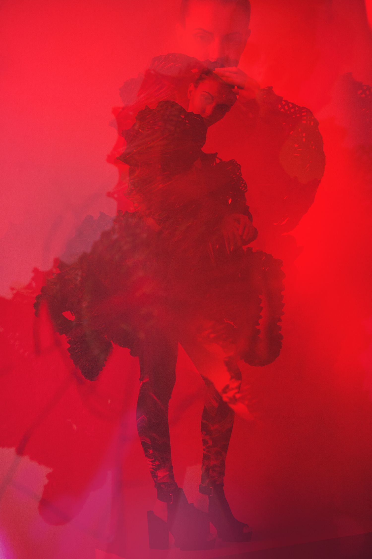 Silhouette in dramatic red lighting creating mysterious atmospheric effect.
