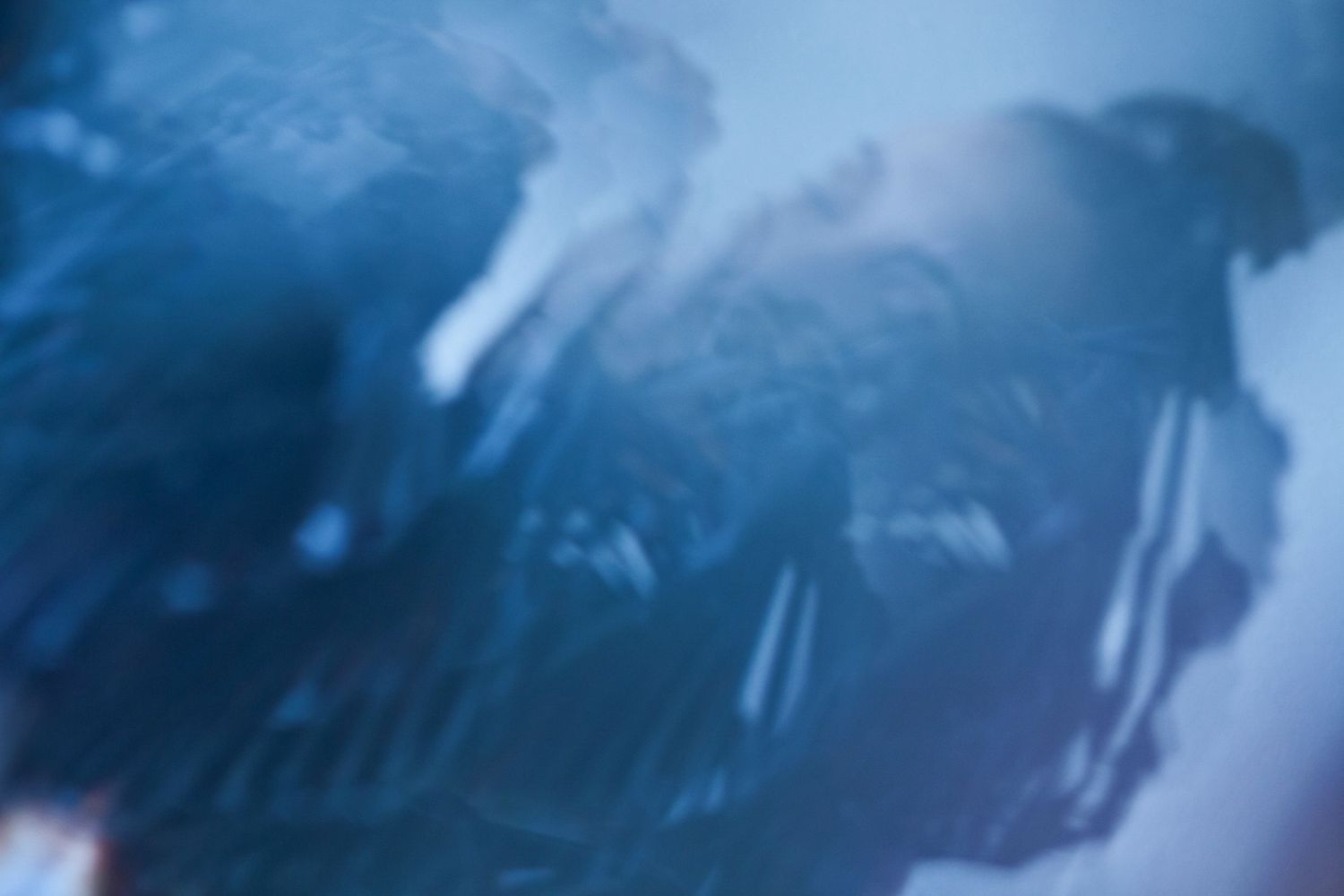 Abstract blue tinted photograph with blurred ethereal effects.