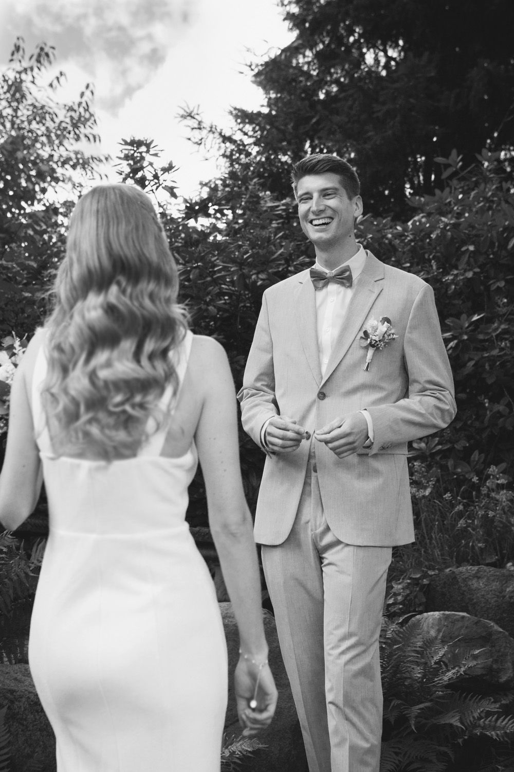 Black and white wedding photos showing couple interacting outdoors.