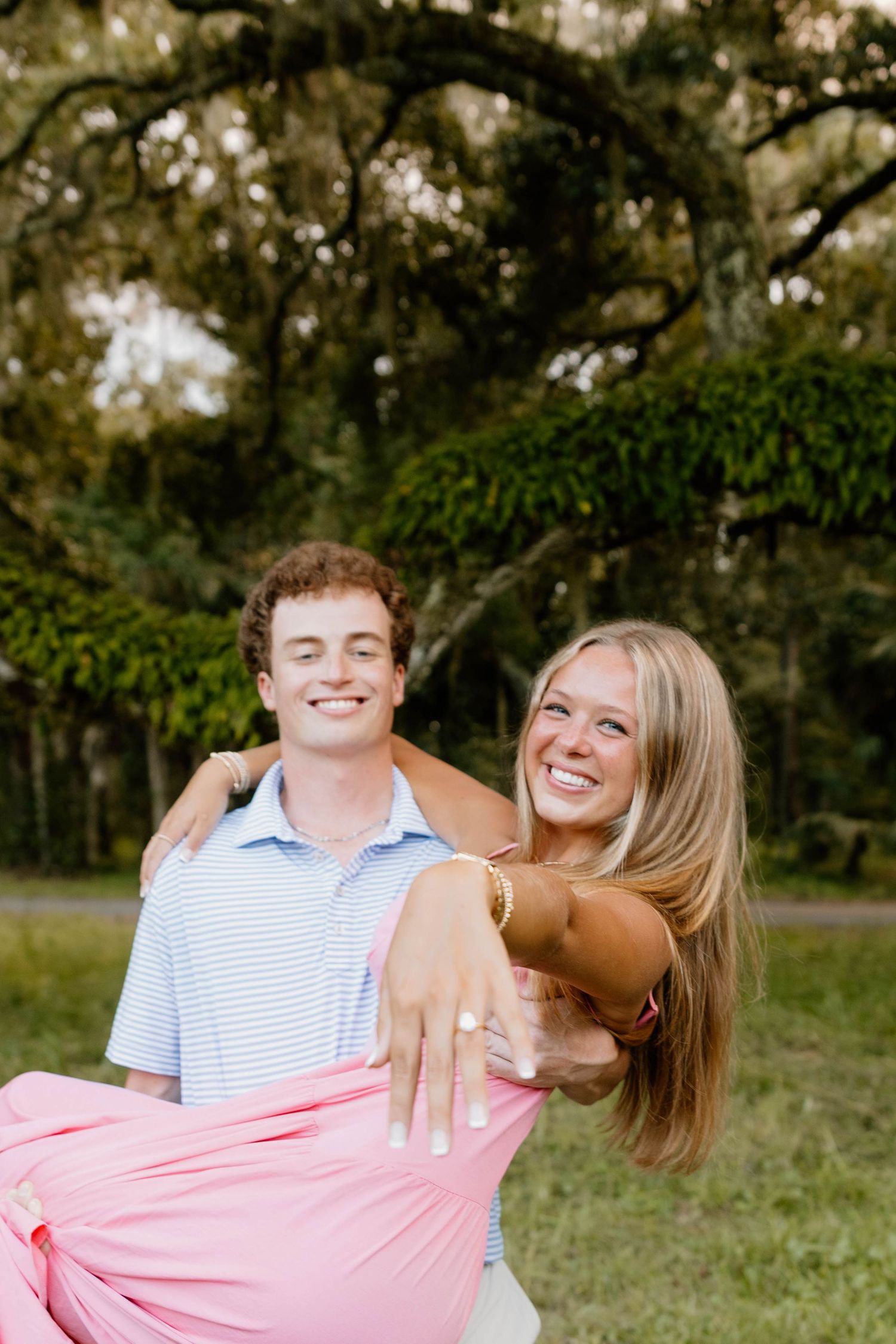 A mother and son share joyful laughter together while embracing outdoors in a natural setting.