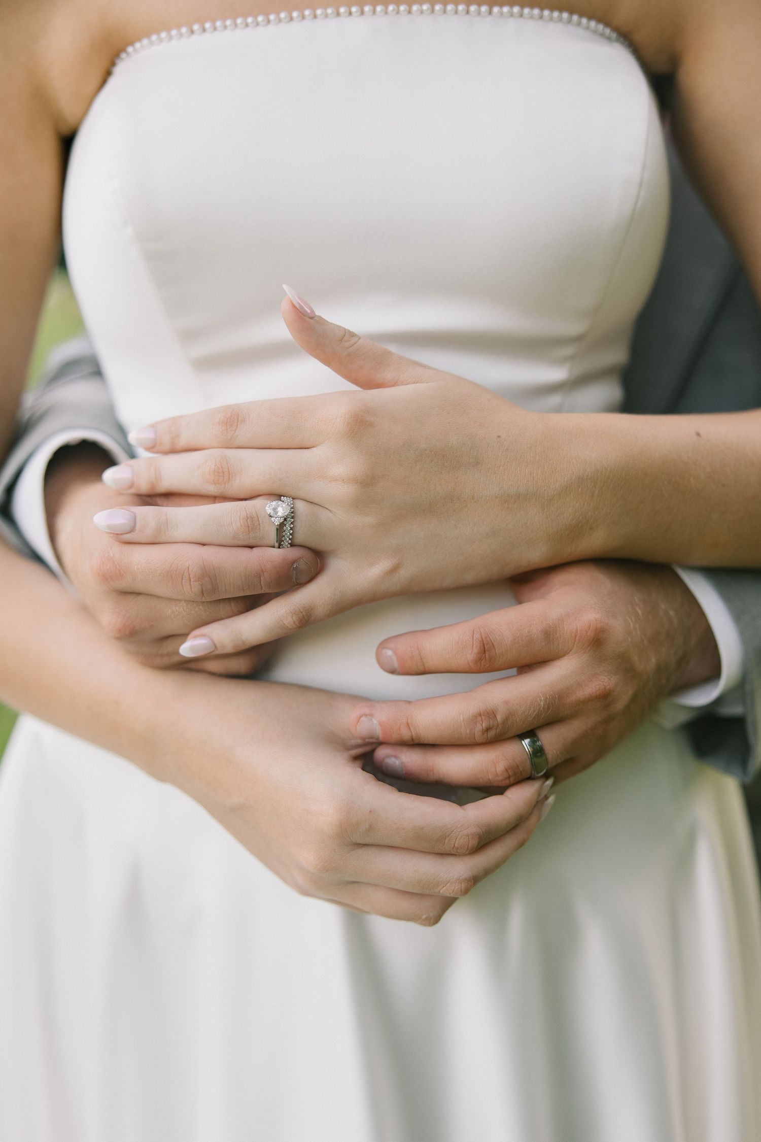 Close-up series of hands with engagement rings against a white dress, showing various angles and poses.