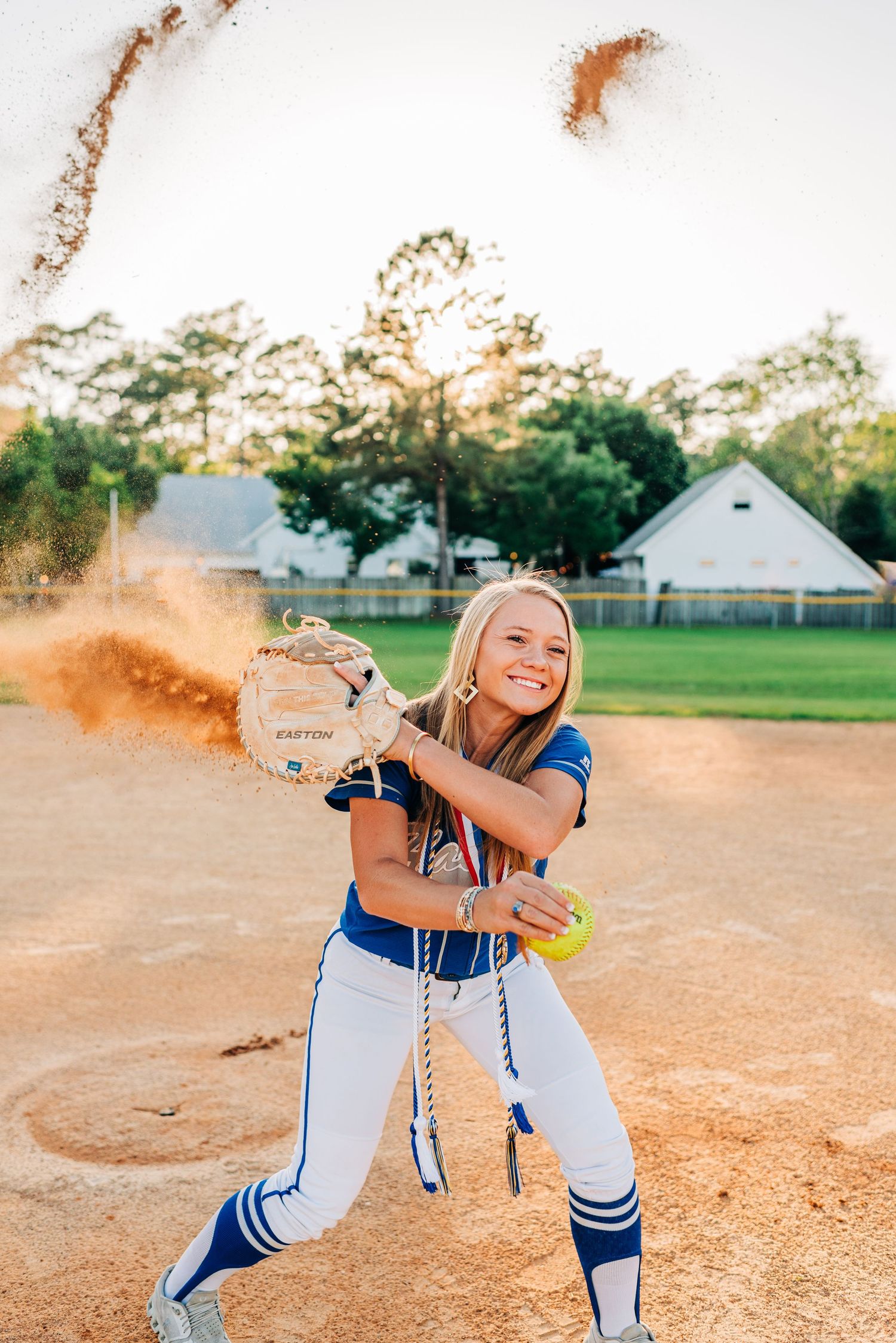 Dynamic softball action shots showing player in blue and white uniform creating dust clouds on dirt field.