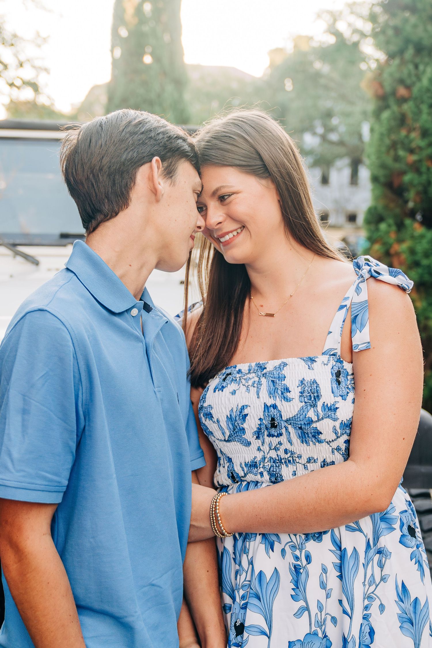 Intimate portrait of couple in blue outfits sharing tender moment.
