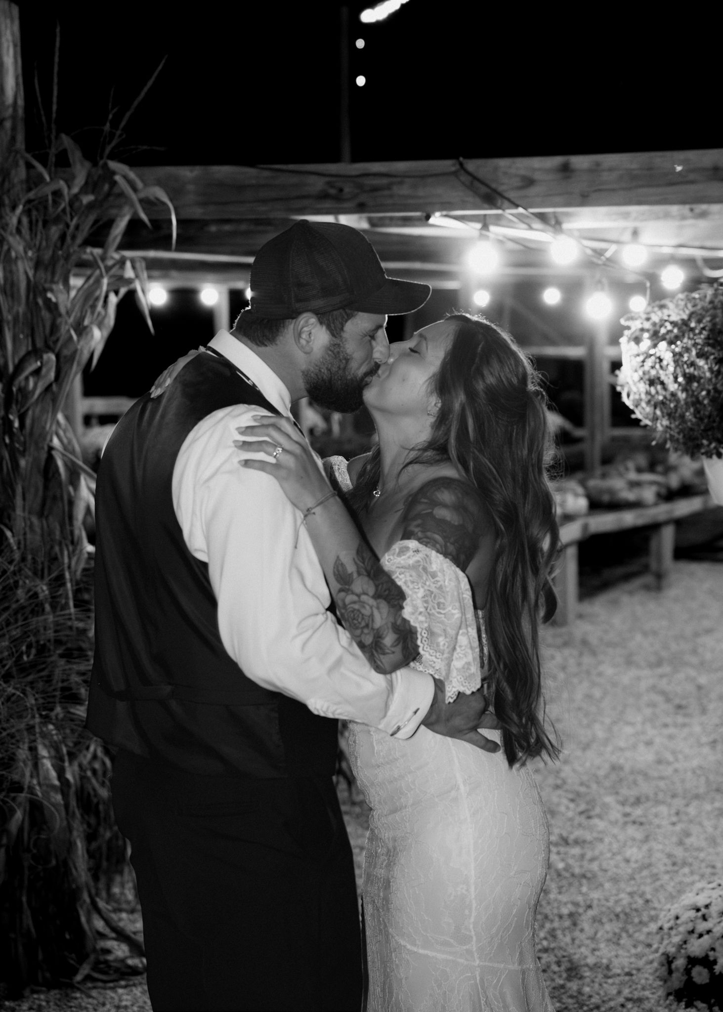 A romantic black and white photo series showing a couple dancing and embracing at an outdoor evening reception.