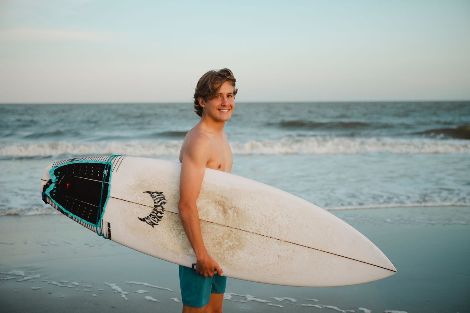 Senior Portrait of Ayden class of 2025. Location Bradley Beach Hilton Head Island, SC. Ocean and surfboard, surfer