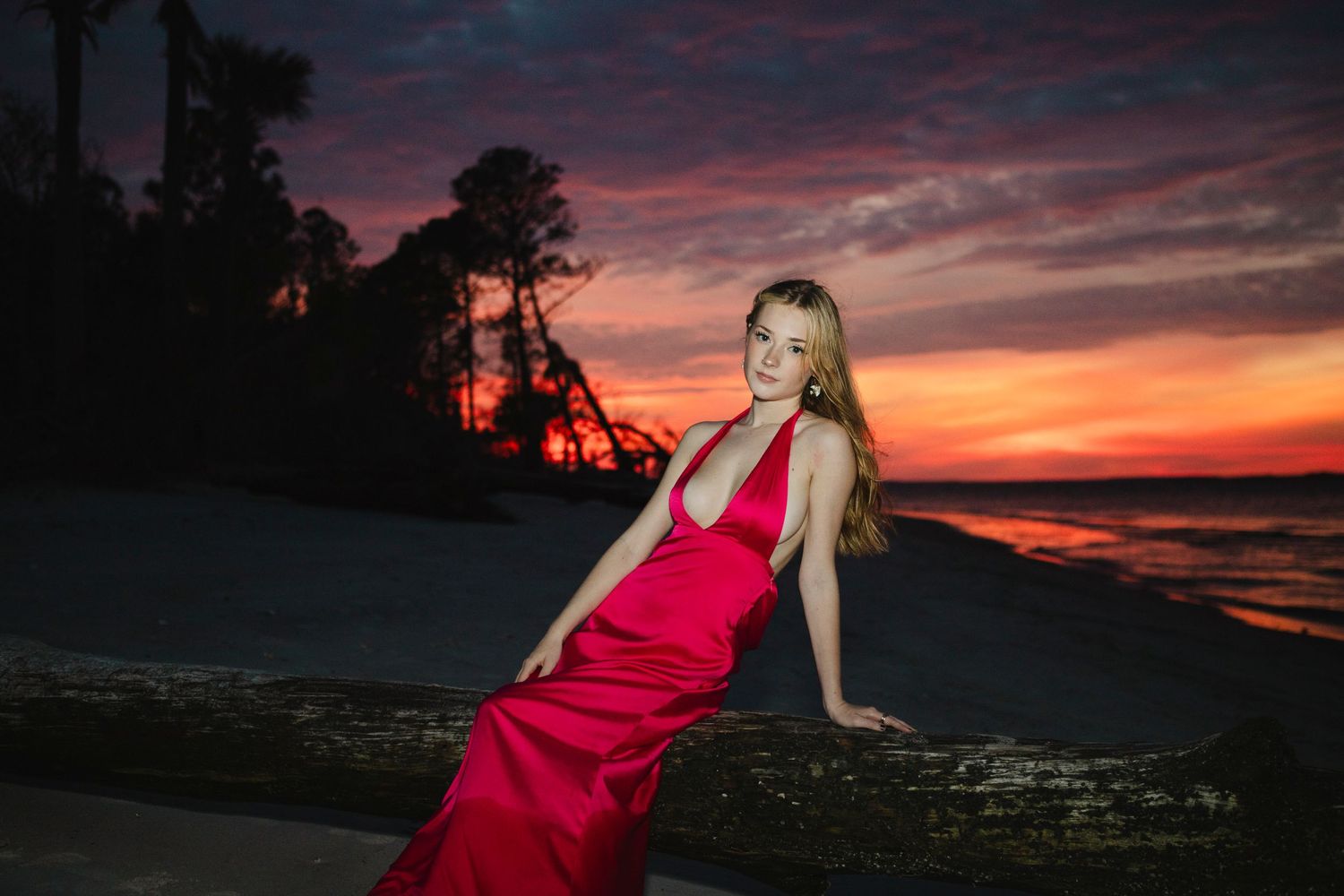 Senior Portrait of Kaylee class of 2025. Location Dolphin Head Hilton Head Island, SC. Sunset at the ocean. Red dress