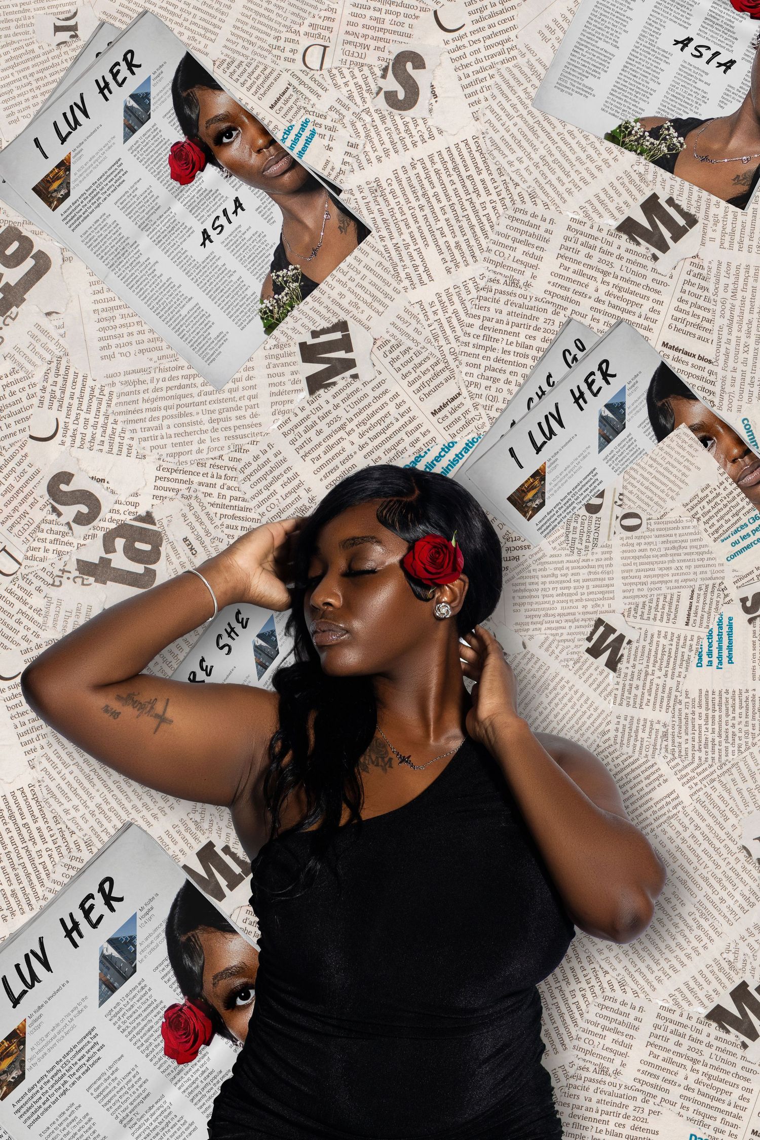 Woman with red roses in hair lies against newspaper collage backdrop featuring repeated magazine pages.