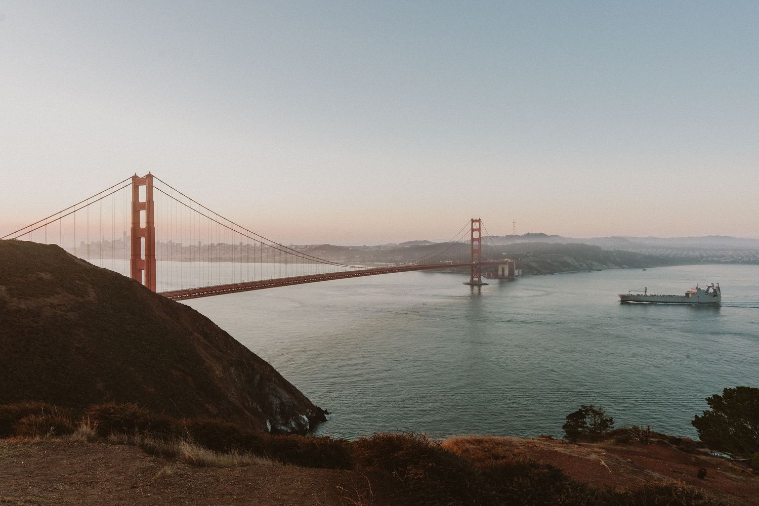 Panoramic view of the Golden Gate Bridge in San Francisco Bay on a misty morning.