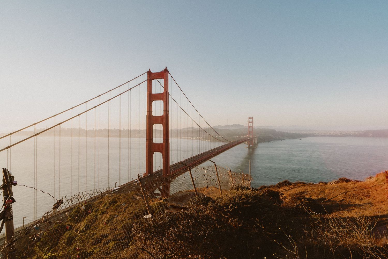 Scenic panorama montage of the iconic Golden Gate Bridge in San Francisco on a misty morning.