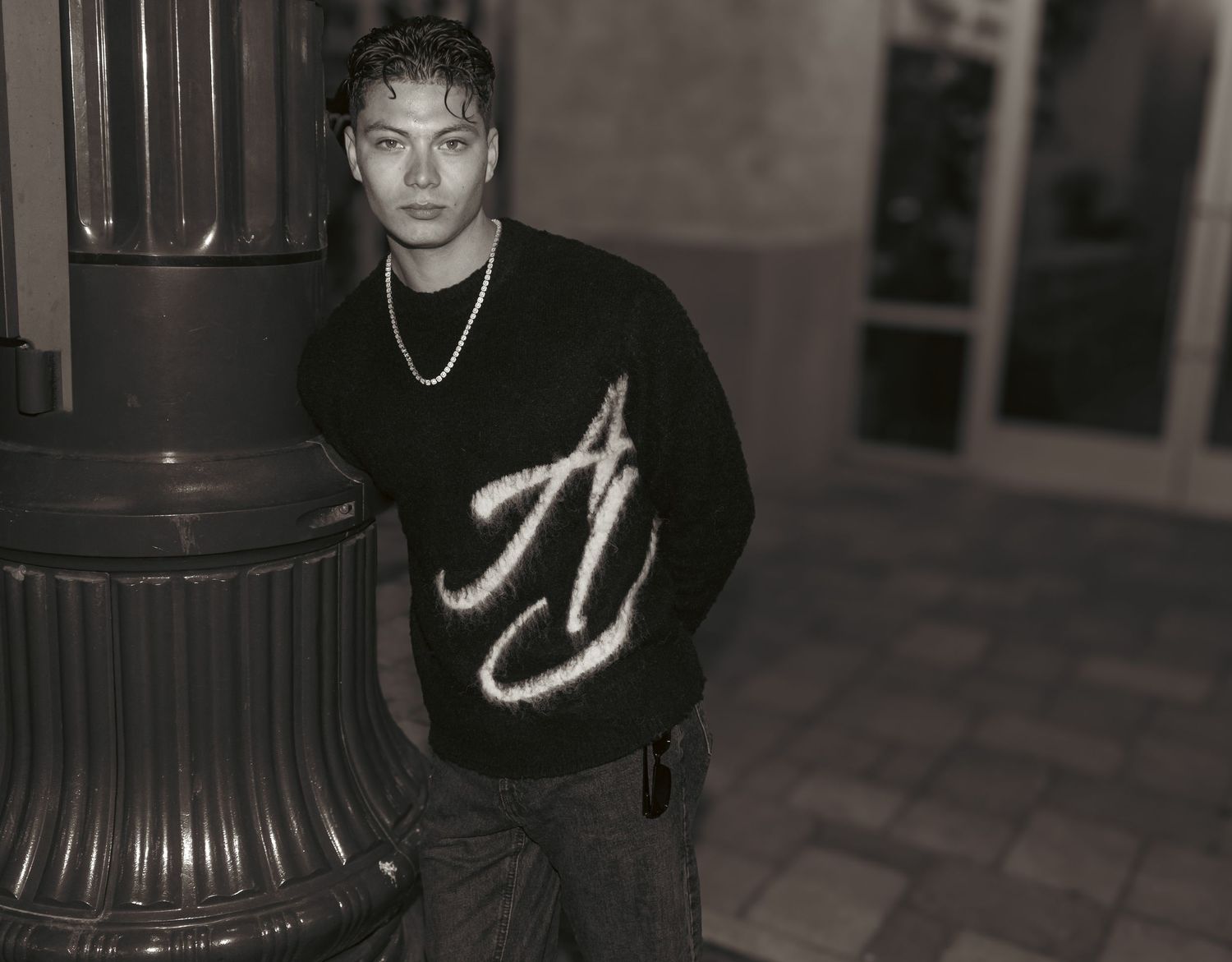 A black and white portrait series with dramatic lighting and shadows for a luxury European streetwear company