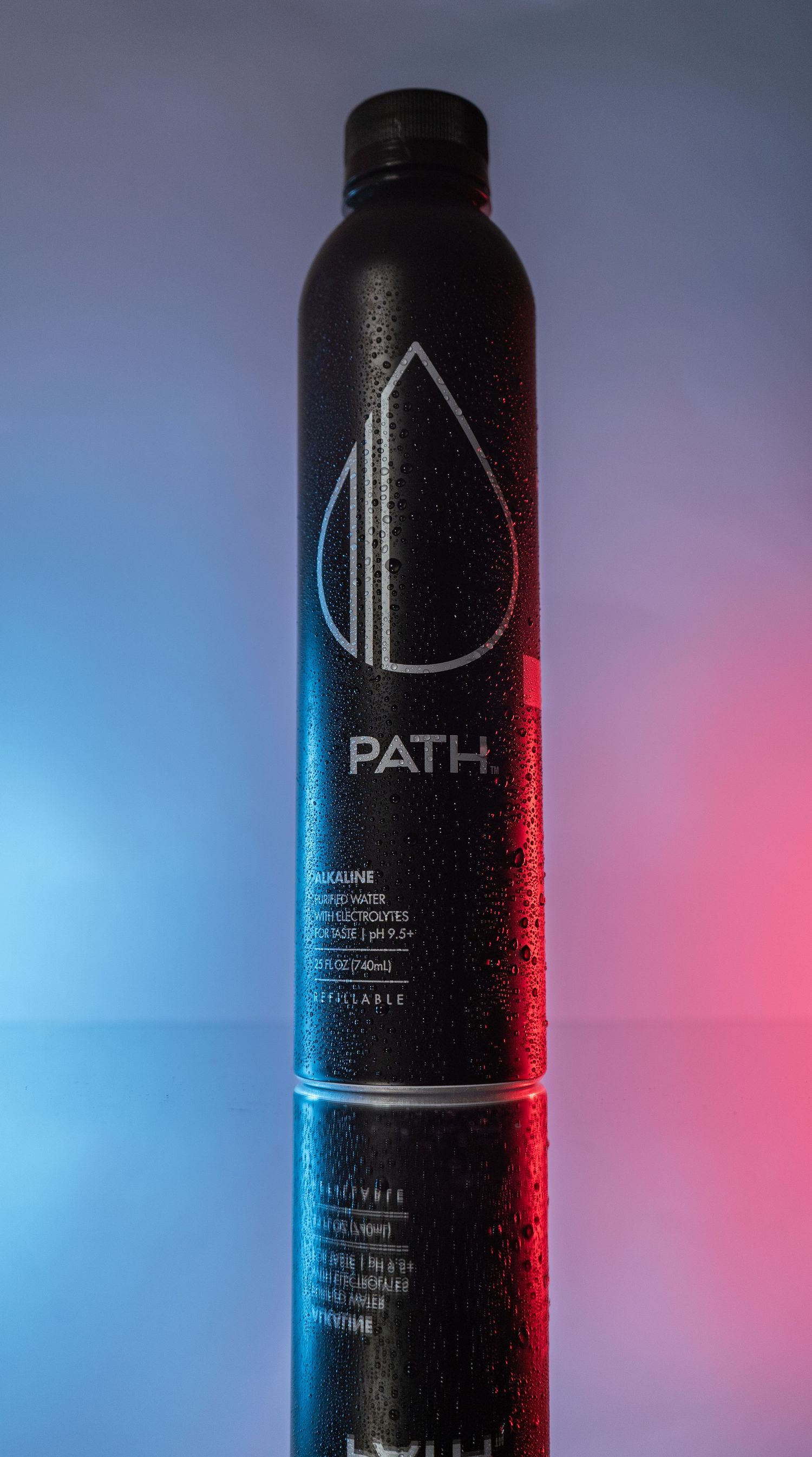 Sleek black PATH water bottle with minimalist droplet logo against blue and red gradient background.