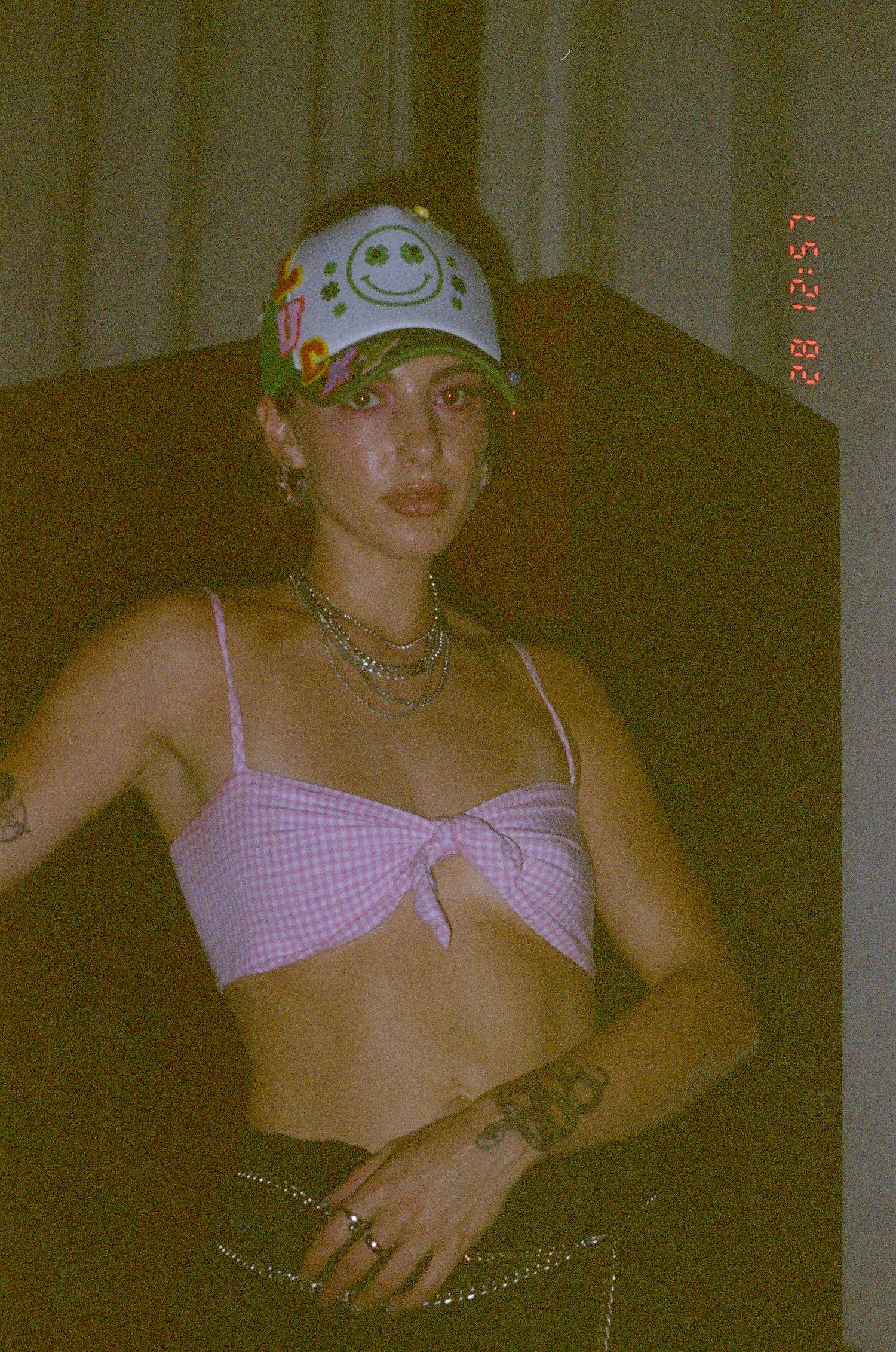 Retro film photo featuring pink gingham patterns and casual style.