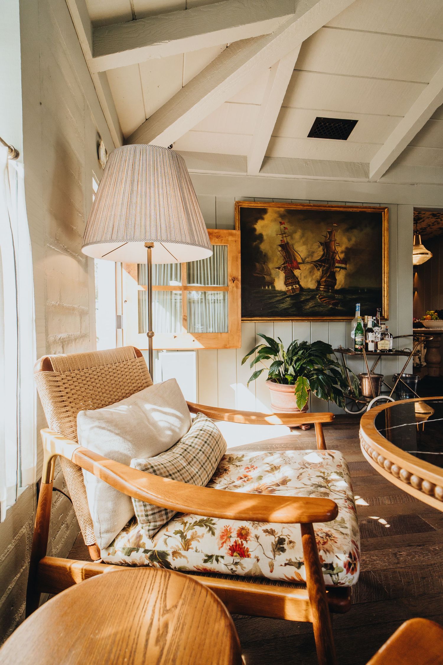 Cozy bohemian attic lounge with wooden beams, vintage furniture, and warm lighting showcasing a comfortable seating area.