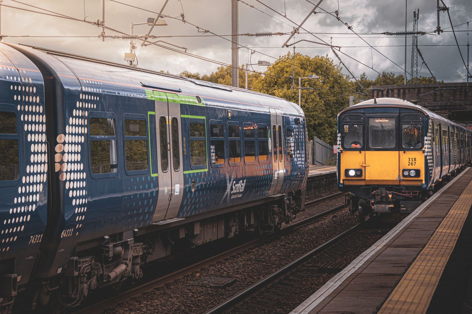 Two Scotrail trains crossing at a station.