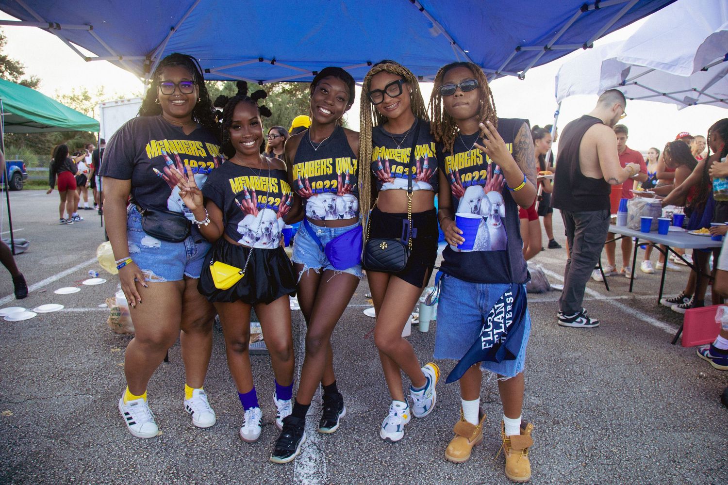 Group photo of people wearing coordinated athletic wear at outdoor event.