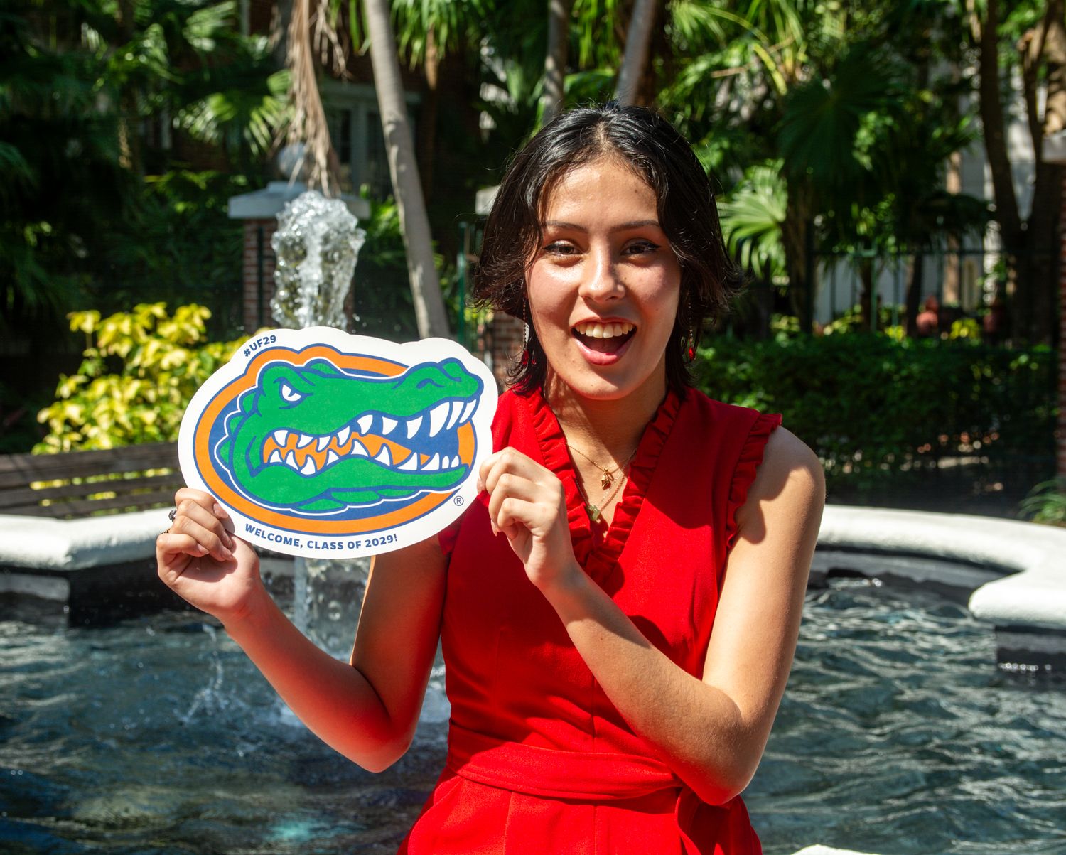 Enthusiastic display of university pride with Florida Gators mascot logo near campus fountain.