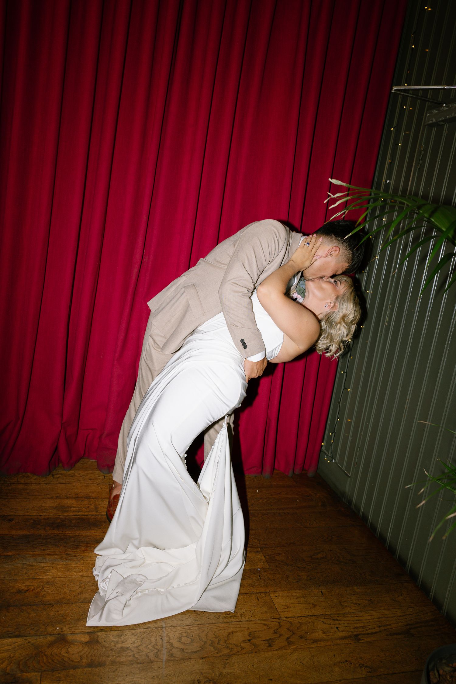 A sequence of dance movements showing a person in white clothing bending backwards against a red curtain backdrop.