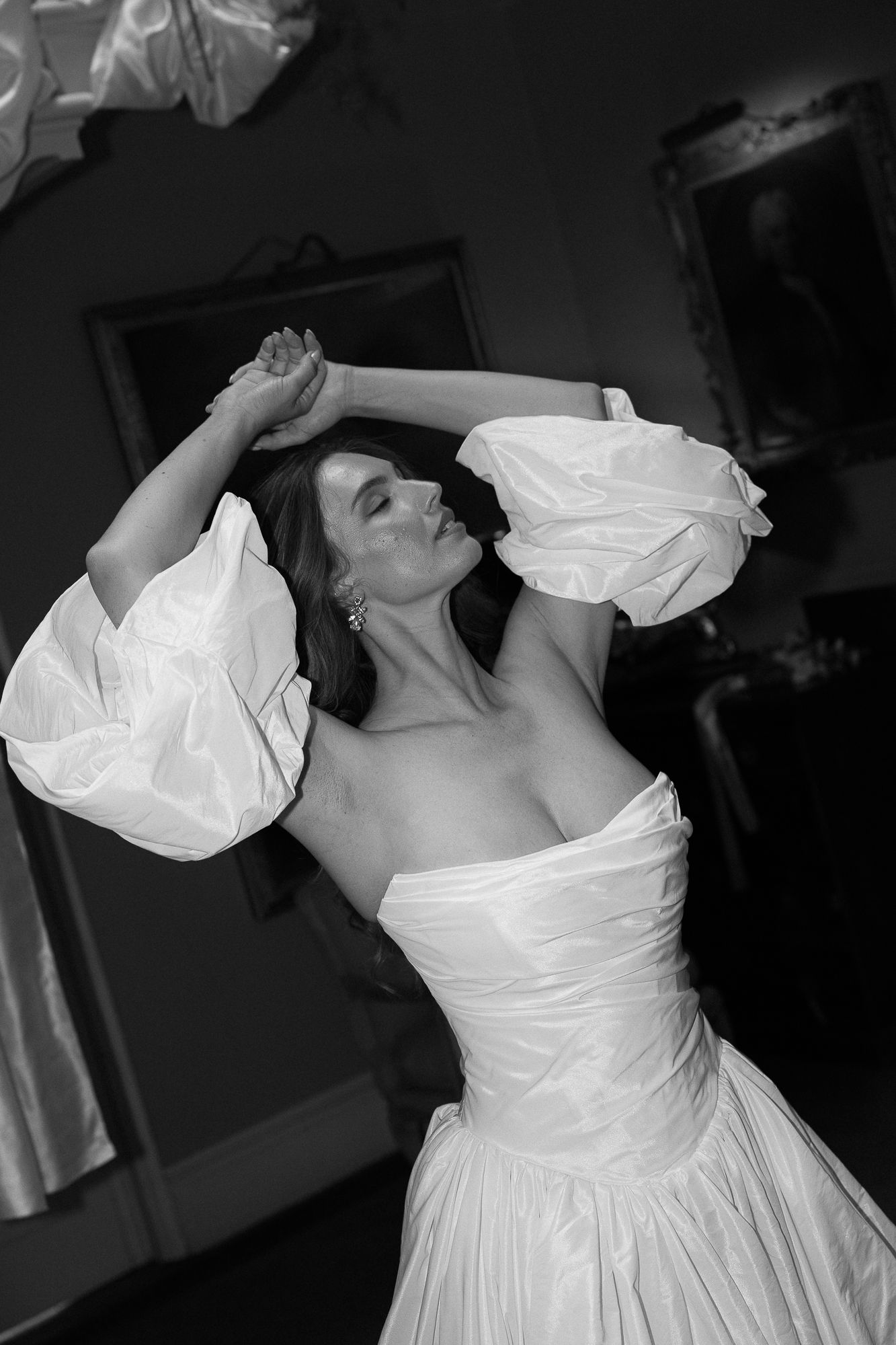 Black and white photo series showing flowing movement in a white wedding dress against a dark background.
