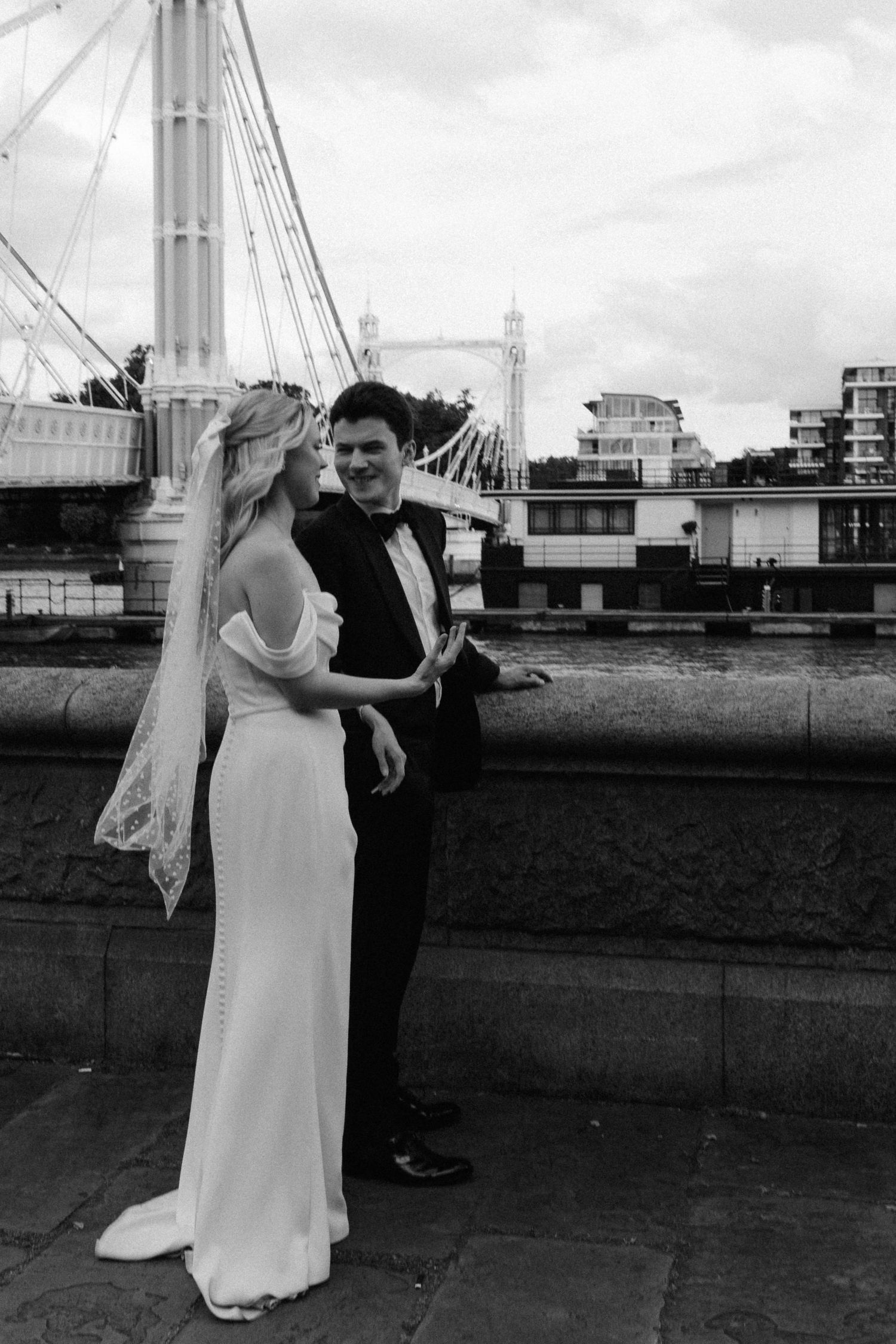 A black and white wedding photo sequence shows a couple dancing together on a rooftop with city buildings in the background.