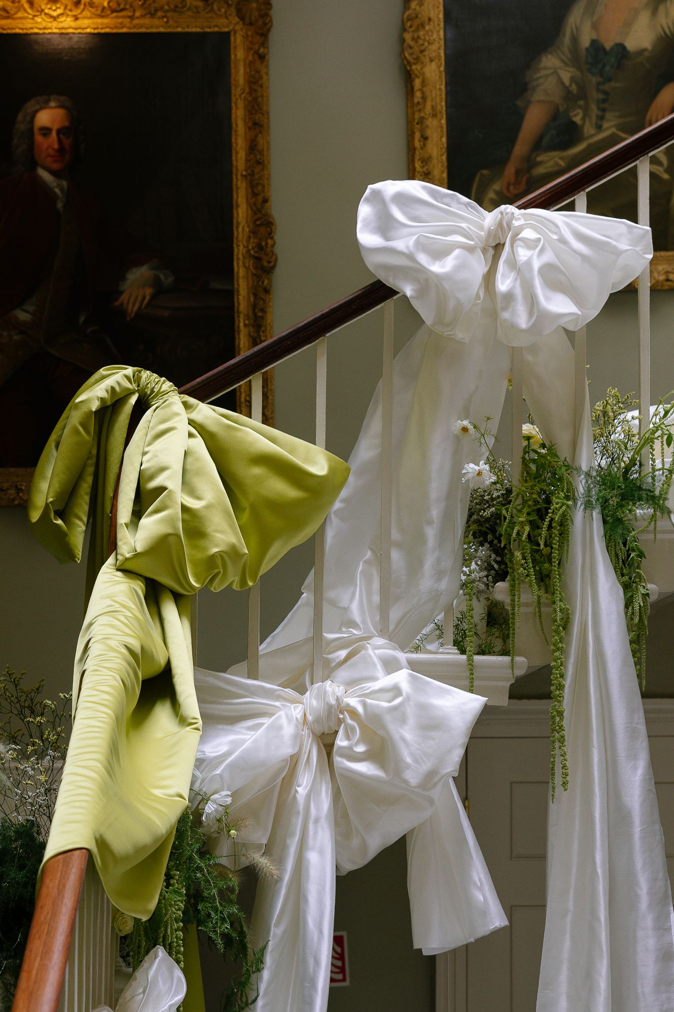 White fabric bows and lime green decorative elements adorn a display against a light-colored wall.