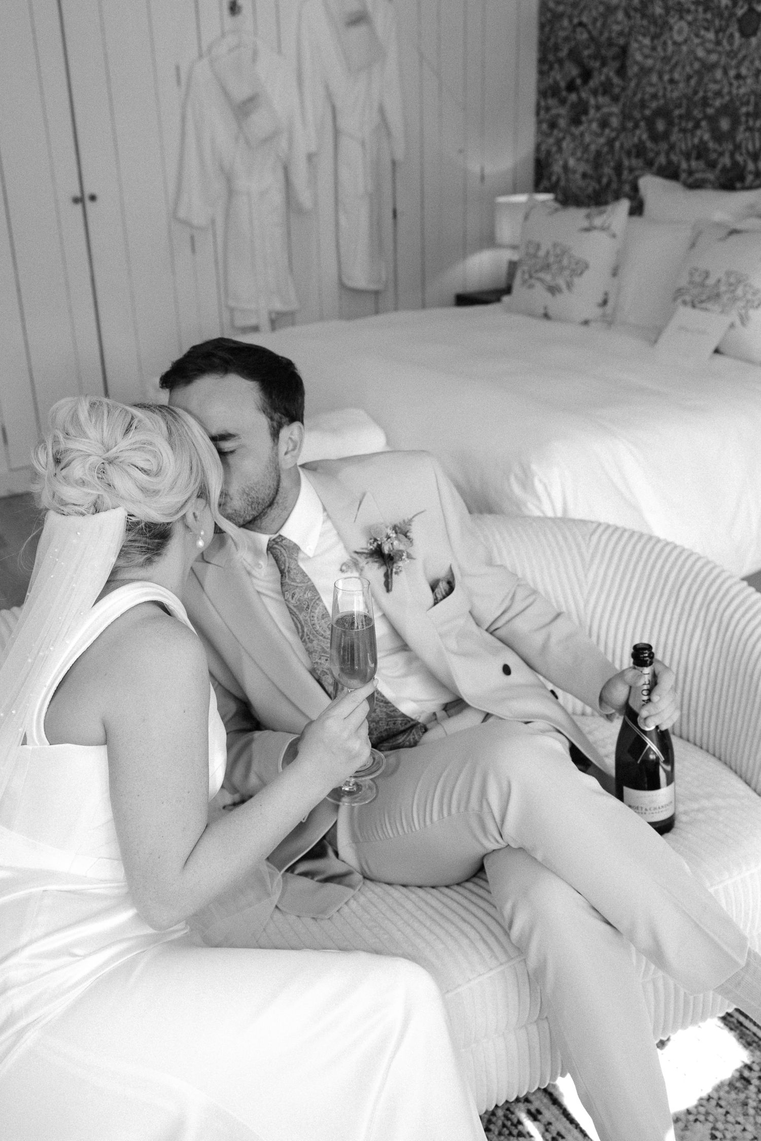 A series of black and white photographs showing someone resting on a white couch or bed.
