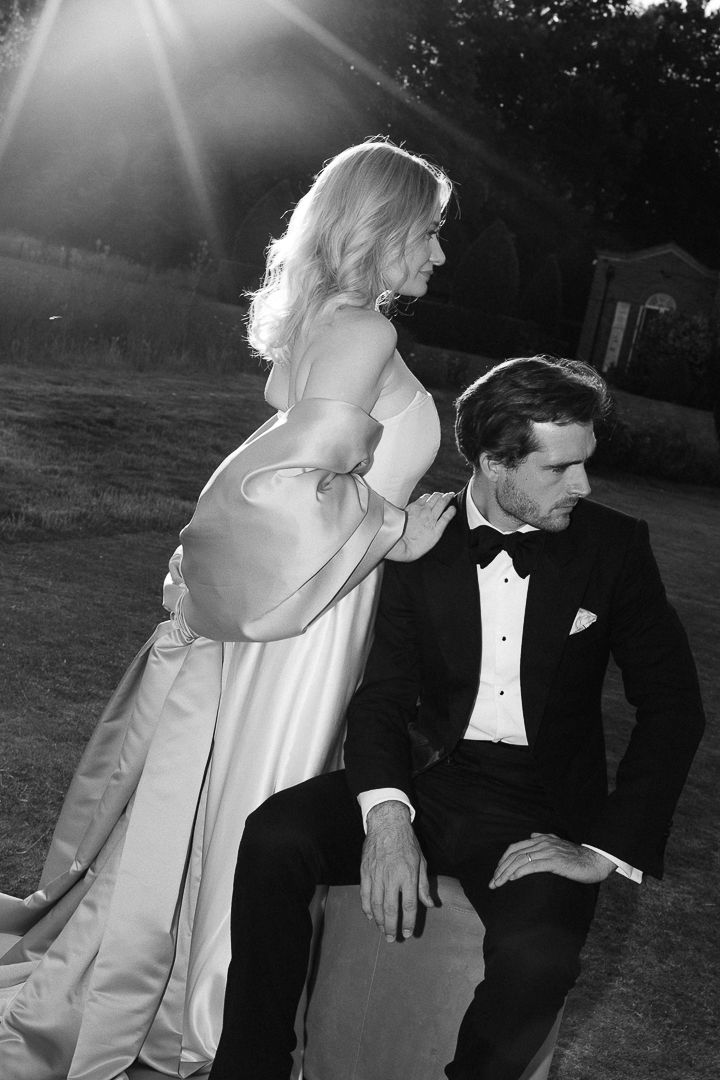A black and white photo sequence shows a couple in formal wedding attire dancing together in an outdoor setting.