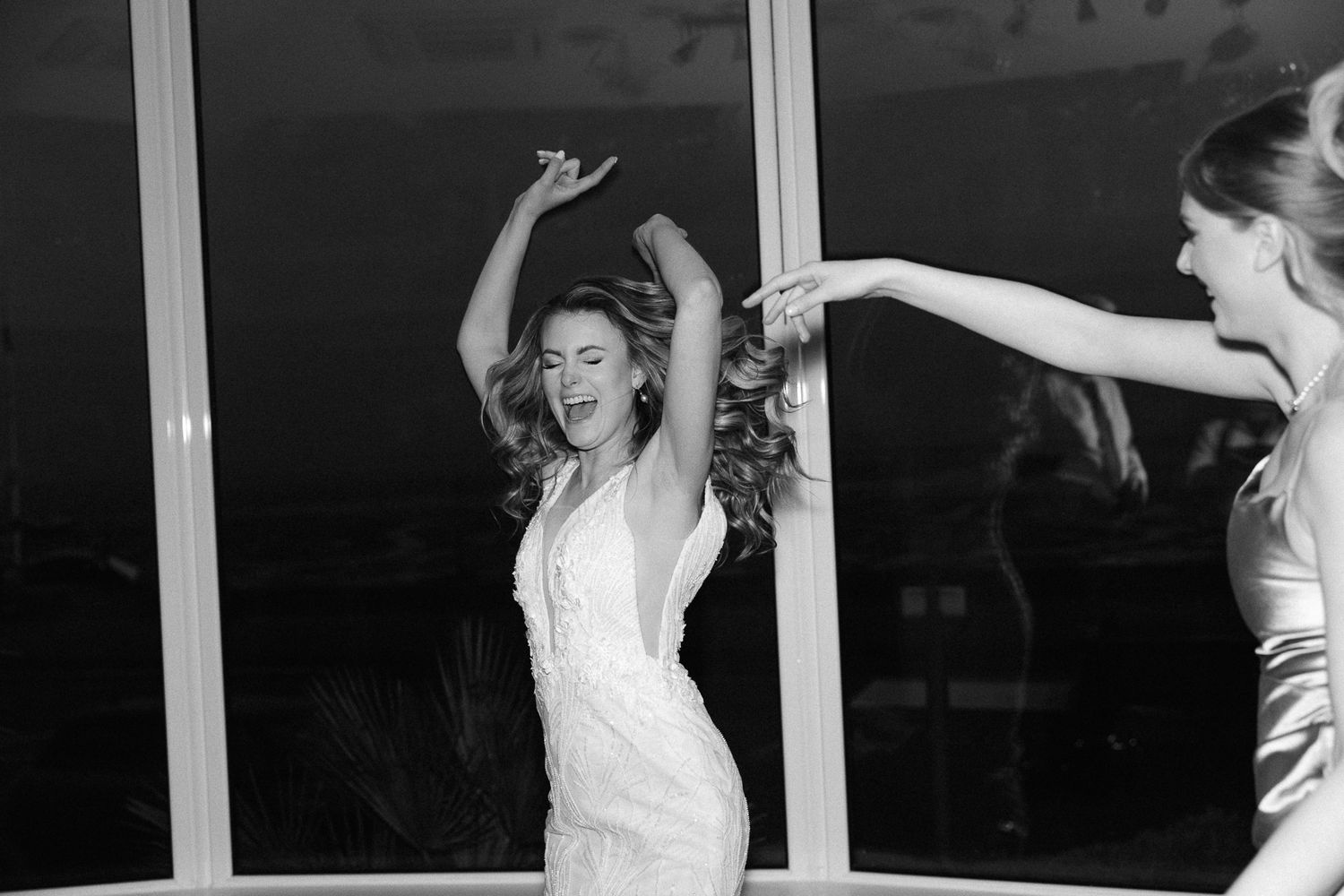 A series of black and white photos showing a person dancing joyfully in different expressive poses.