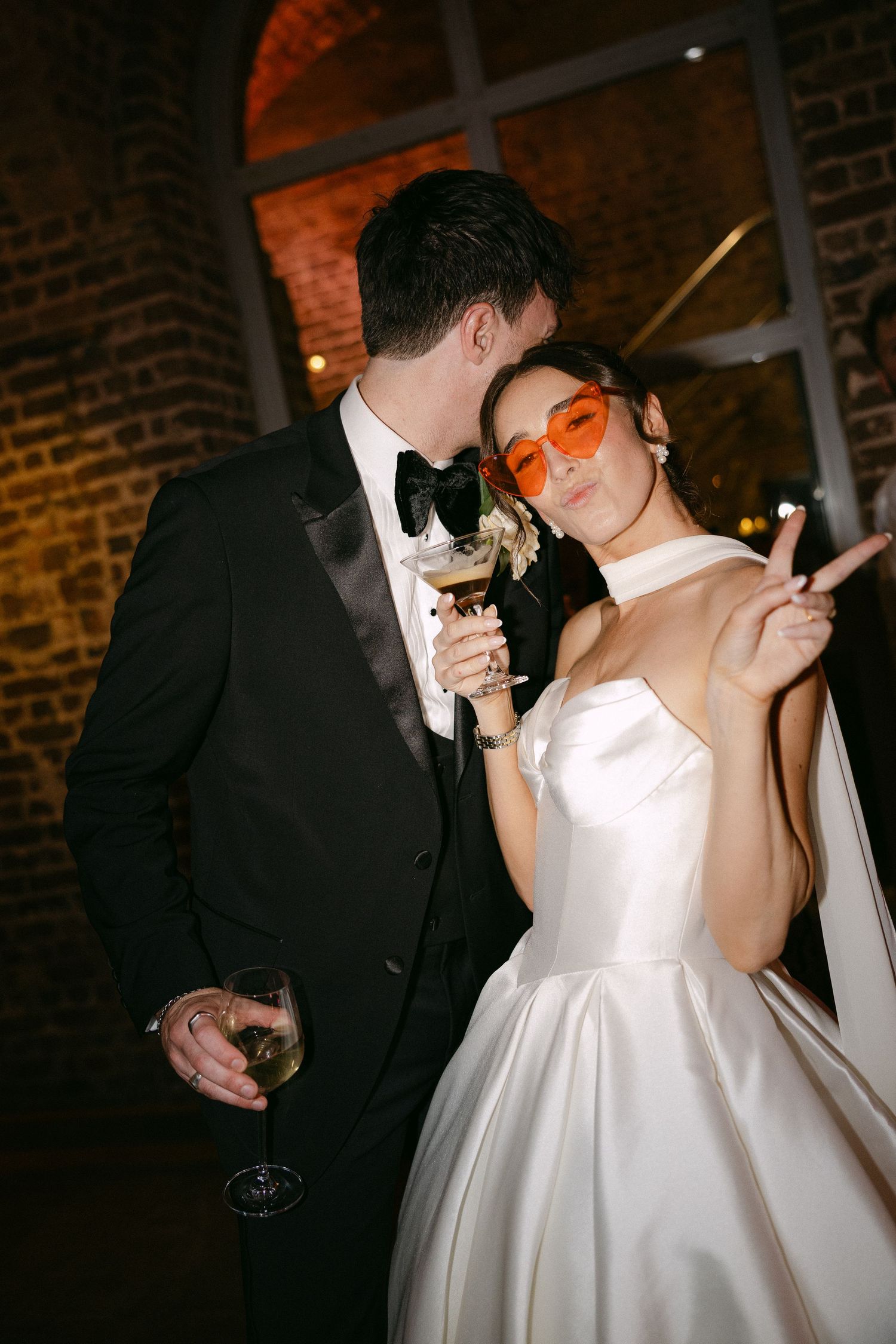 A romantic wedding dance sequence showing a couple in formal attire at a rustic brick venue.