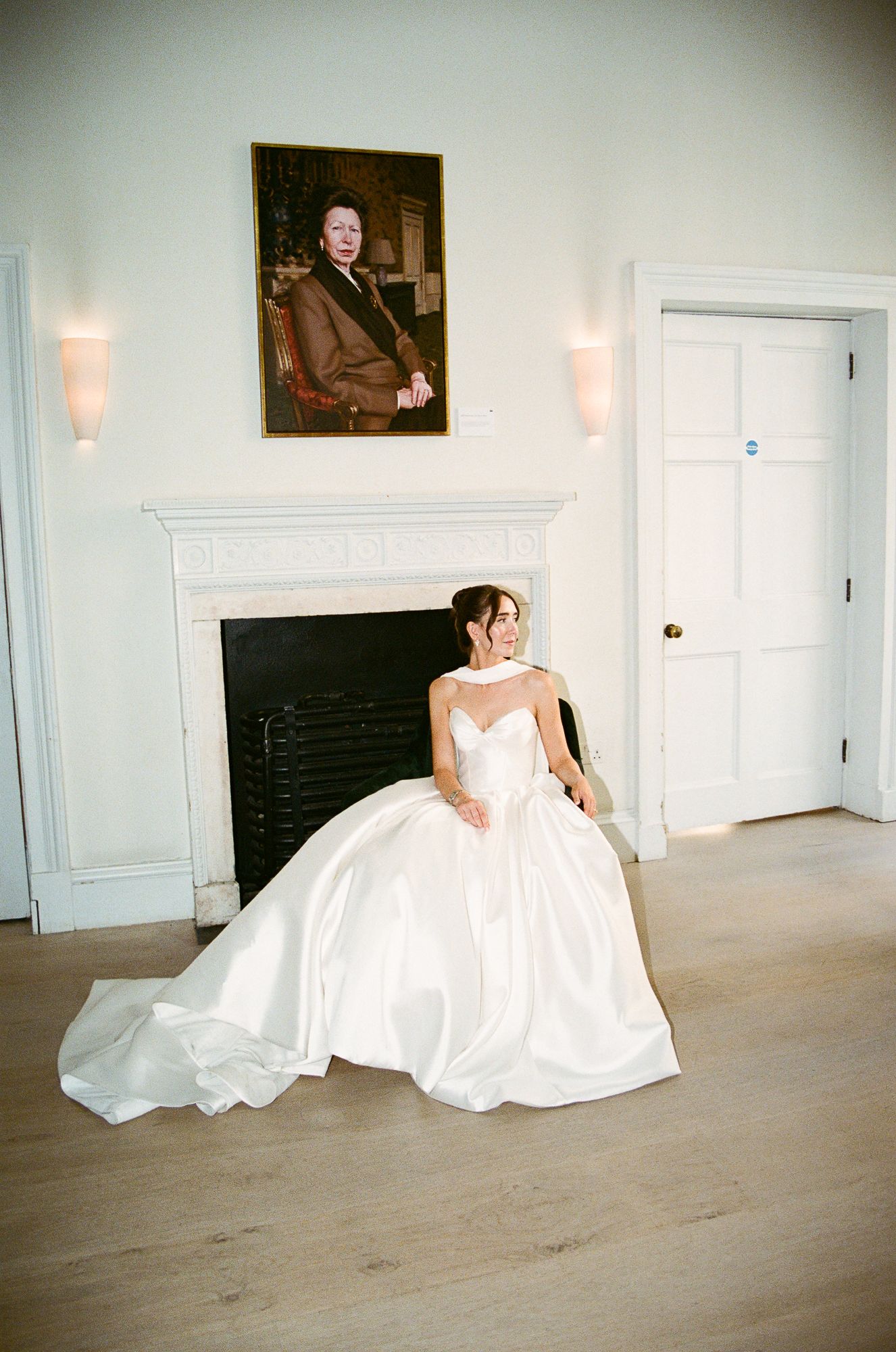 A bride in a flowing white ball gown poses gracefully across five sequential photos in an elegant white room.