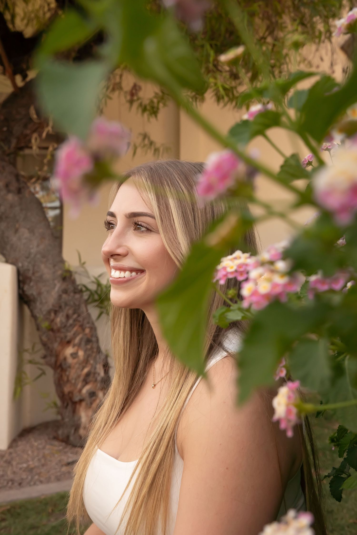 Dreamy senior photos in Arizona desert and beautiful flowers with natural poses