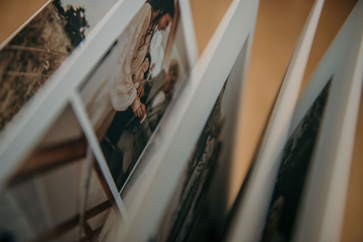 Wedding album pages fanned out showing multiple photographs.