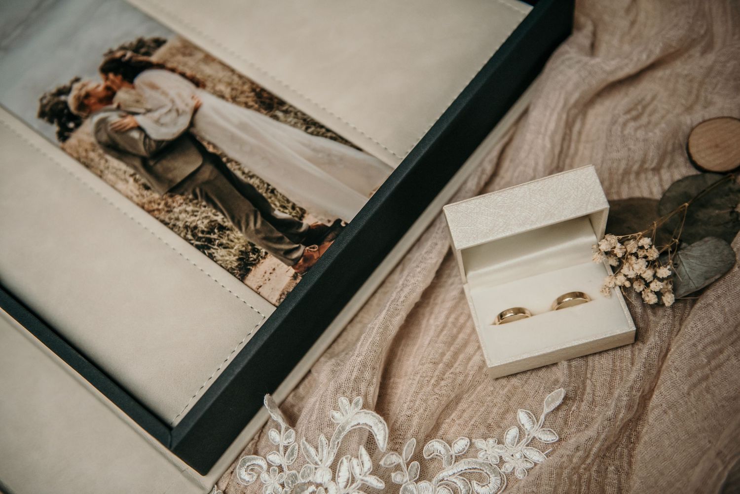 Wedding album layout with photographs arranged on textured fabric.