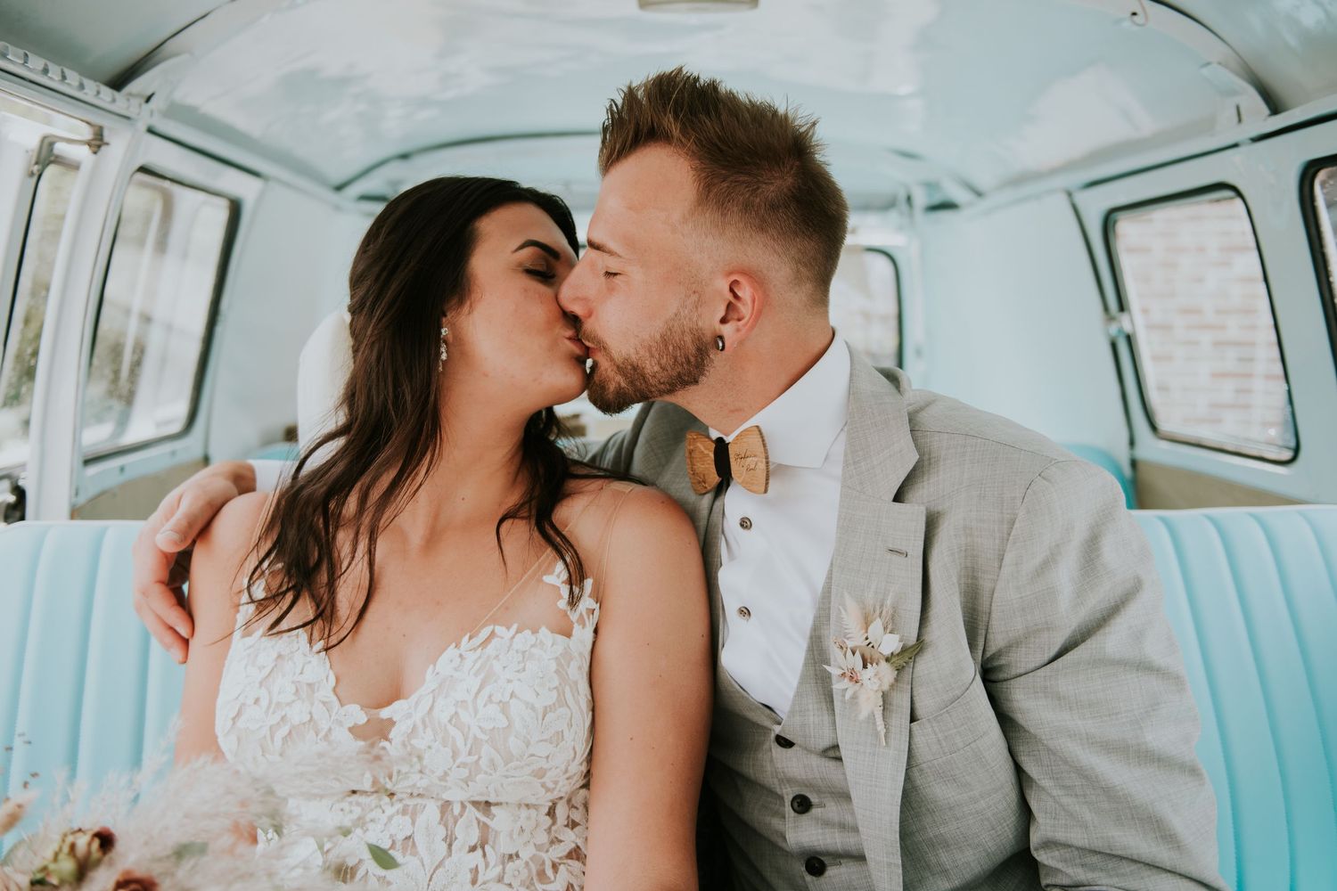 Romantic moments shared inside classic mint green VW bus.