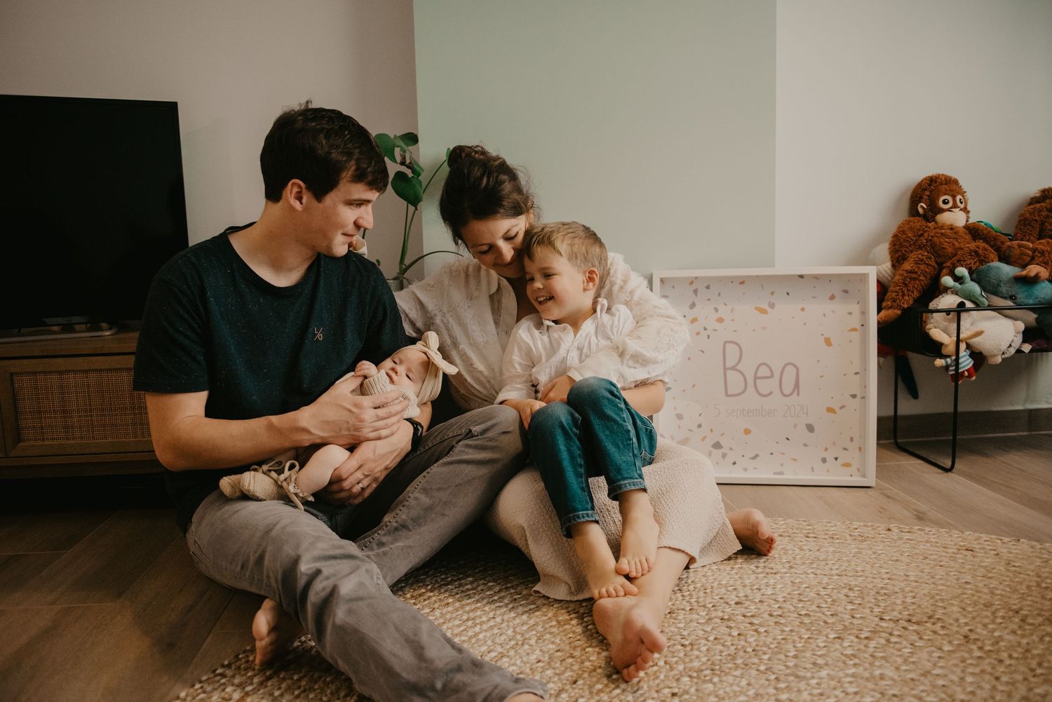 Family sitting together on carpet in living room sharing intimate moment.