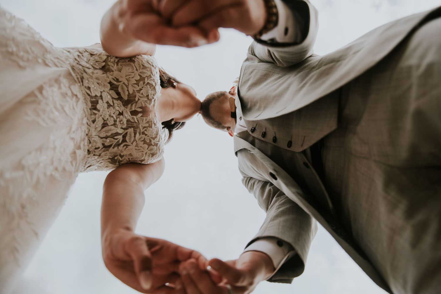 Close-up details of wedding rings being exchanged during ceremony.
